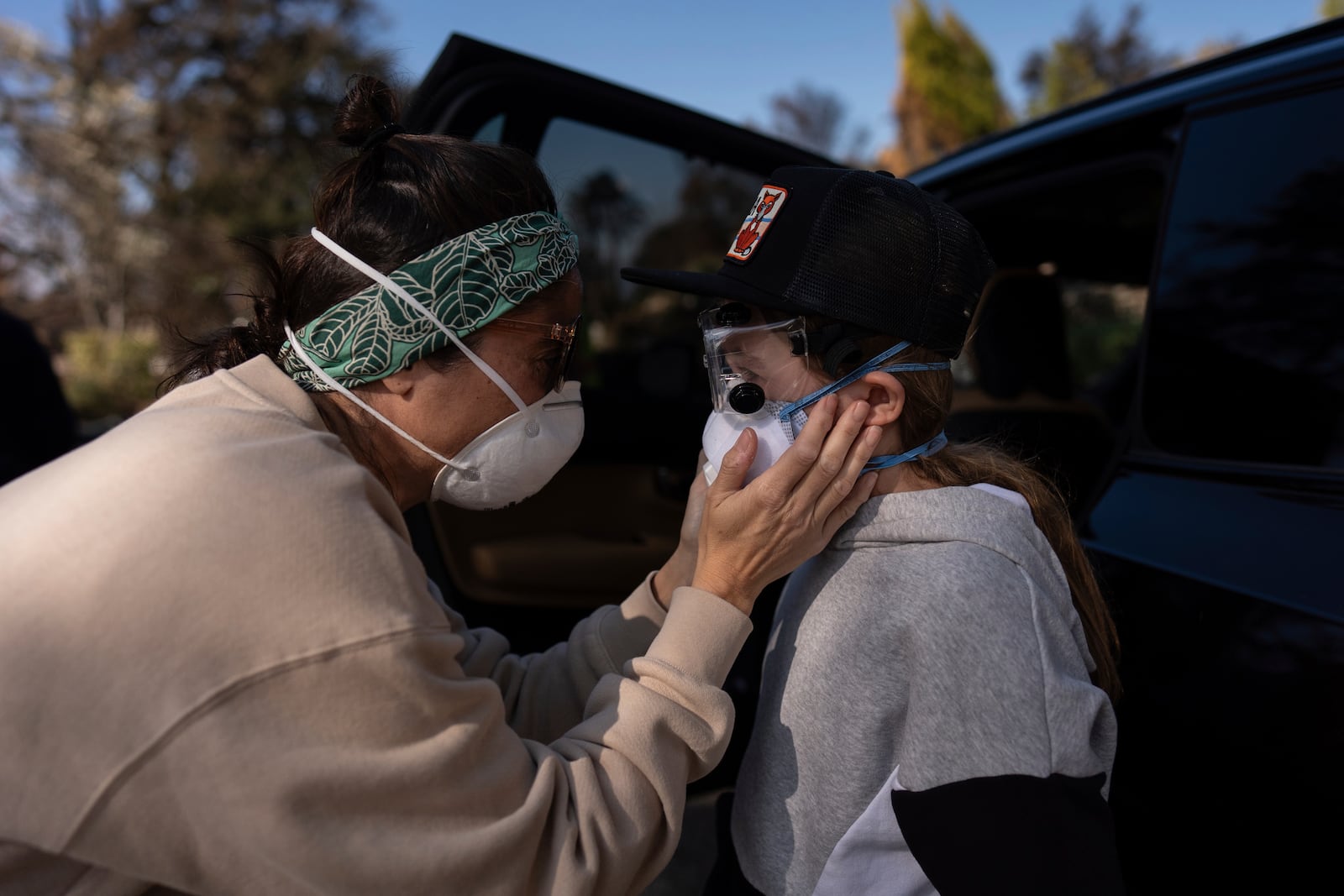 Eaton Fire evacuee Alyson Granaderos, left, sobs while trying to comfort her son, Ceiba Phillips, 11, as he visits their home for the first time since the fire in Altadena, Calif., Saturday, Feb. 8, 2025. (AP Photo/Jae C. Hong)