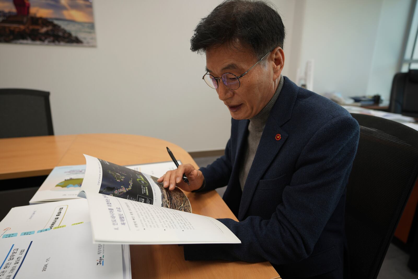 South Korean National Assembly member Moon Dae-Lim looks at a policy report on the state audit authored by him at his office of the National Assembly in Seoul, South Korea, Wednesday, Nov. 27, 2024. (AP Photo/Lee Jin-man)