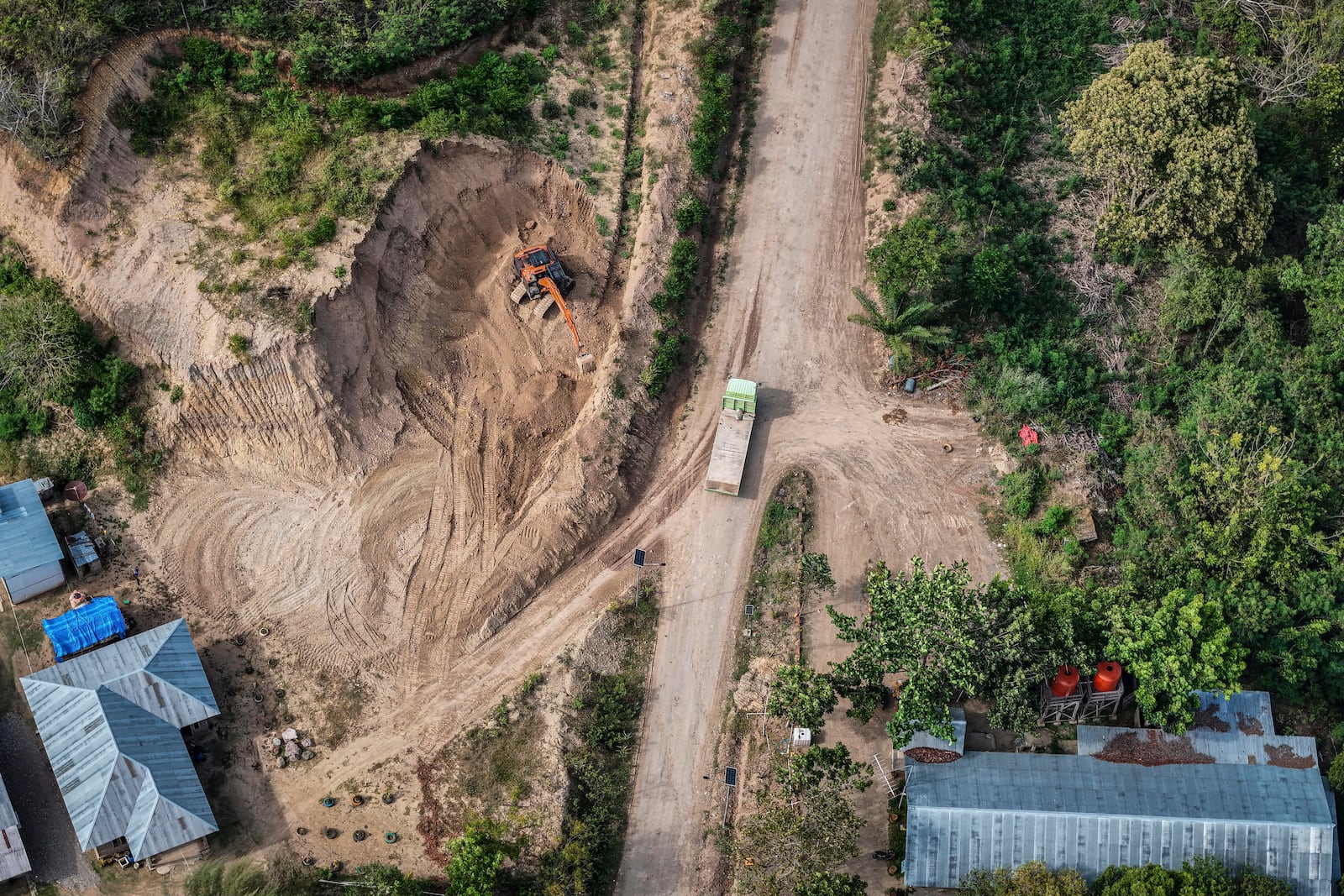 A machine operates near a road leading to the area of wood pellet production companies in Pohuwato, Gorontalo province, Indonesia, Tuesday, Oct. 22, 2024. (AP Photo/Yegar Sahaduta Mangiri)