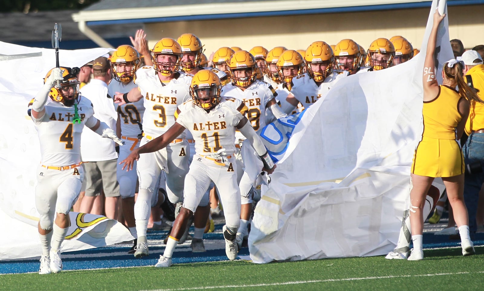 Jack McKelvey (left, 4), Kale Steneman (3) and Marcael O'Neal (11) lead Alter onto the field. Alter defeated host Fairmont 21-7 in a Week 1 high school football game on Thursday, Aug. 29, 2019. MARC PENDLETON / STAFF