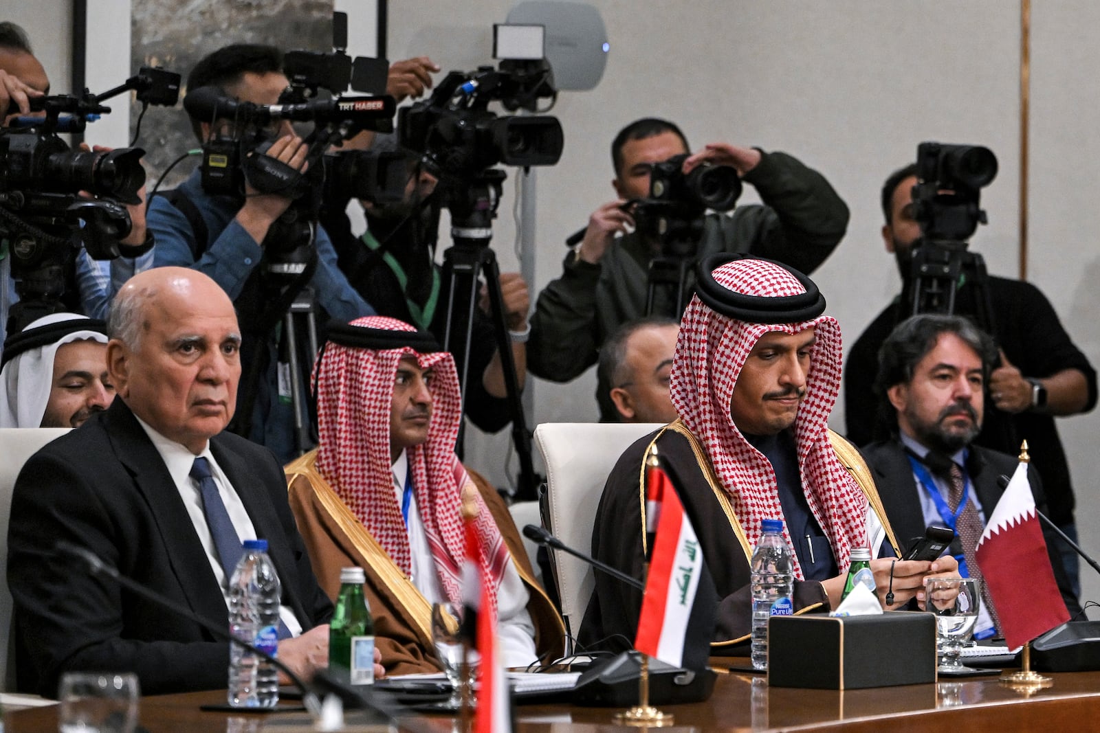 Iraq's Foreign Minister Fuad Hussein, left, and Qatar's Foreign Minister Sheikh Mohammed bin Abdulrahman bin Jassim Al-Thani during a meeting with the foreign ministers of the Arab Contact Group on Syria in Jordan's southern Red Sea coastal city of Aqaba, Saturday Dec. 14, 2024. (Andrew Caballero-Reynolds/Pool via AP)