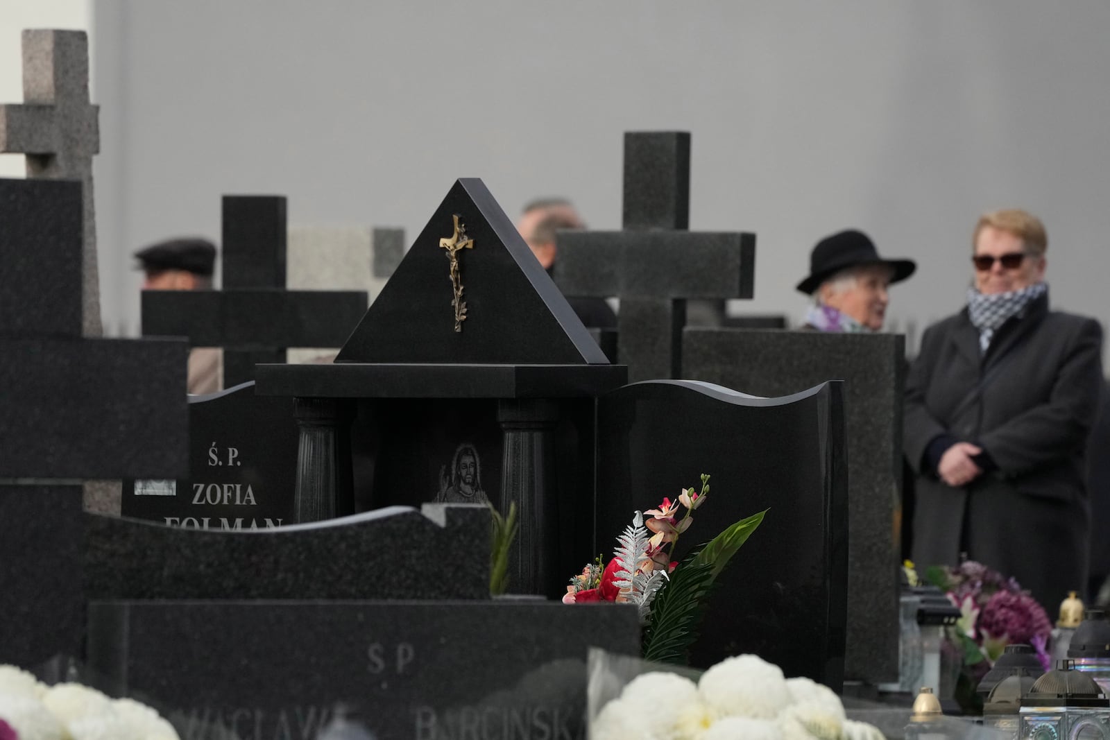 People observe All Saints' Day, a time for reflecting on those who have died, on Friday Nov. 1, 2024, in Zakroczym near Warsaw, Poland. (AP Photo/Czarek Sokolowski)