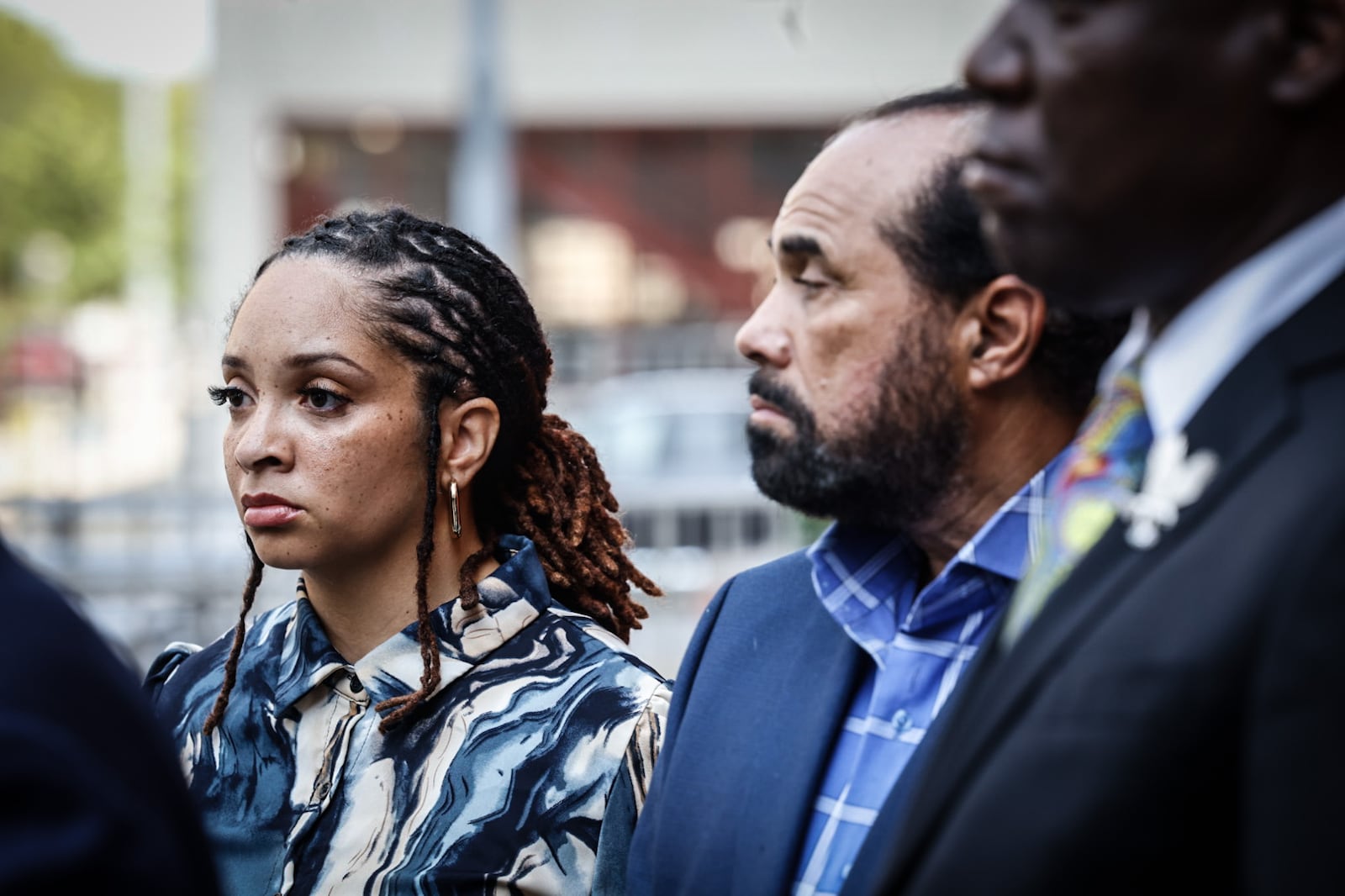 Family members and attorneys representing the family of Colby Ross held a news conference Wednesday, July 31, 2024, in downtown Dayton to discuss the high-speed pursuit by Montgomery County Sheriff's deputies that led to the death of Ross, who was stopped at a red light when his vehicle was struck in May. At left is Chenea Ross, his widow, and Skip Ross, his father. JIM NOELKER/STAFF