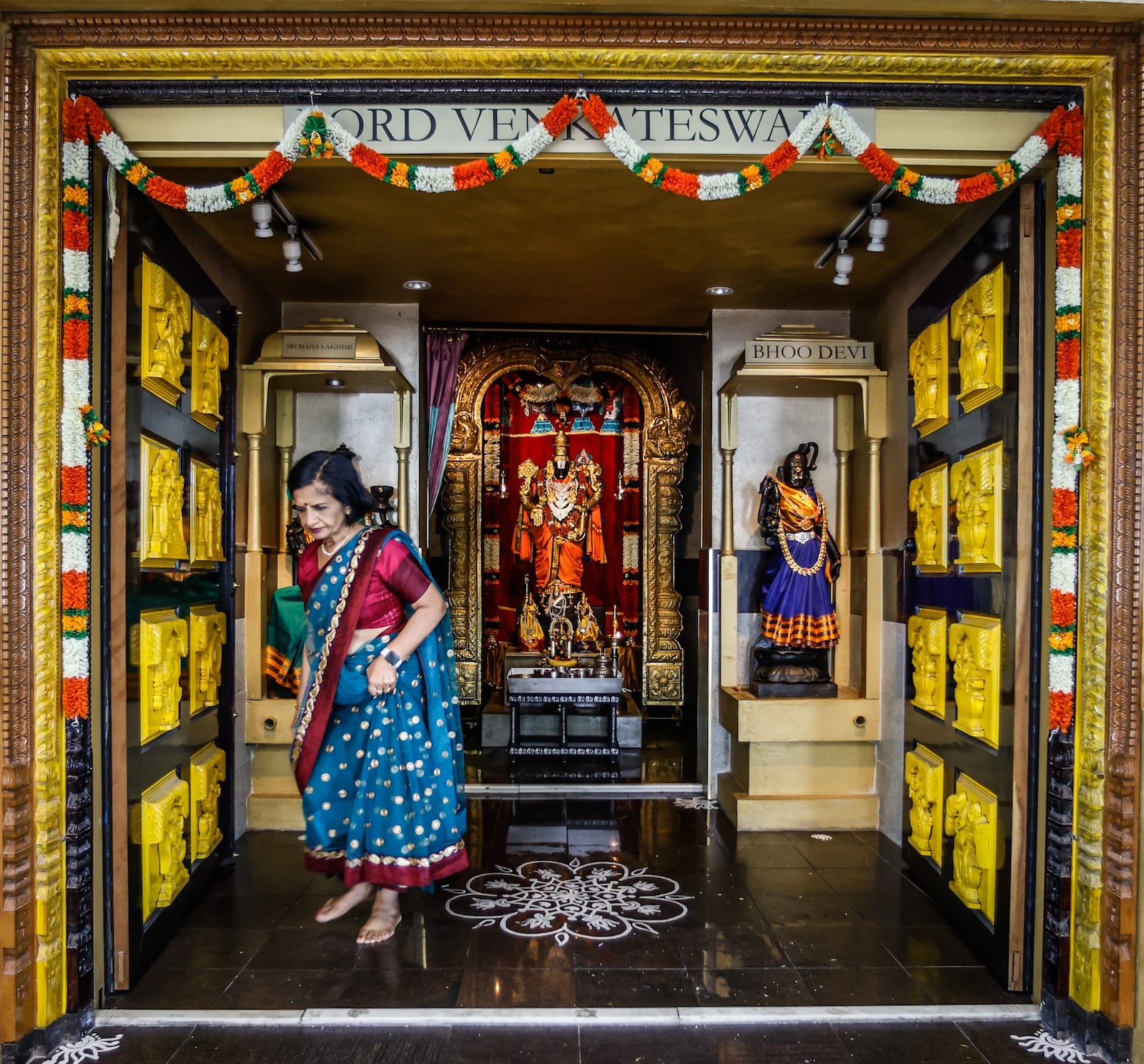 Sunita Agarwal leaves a temple within the Hindu Temple of Dayton. JIM NOELKER/STAFF