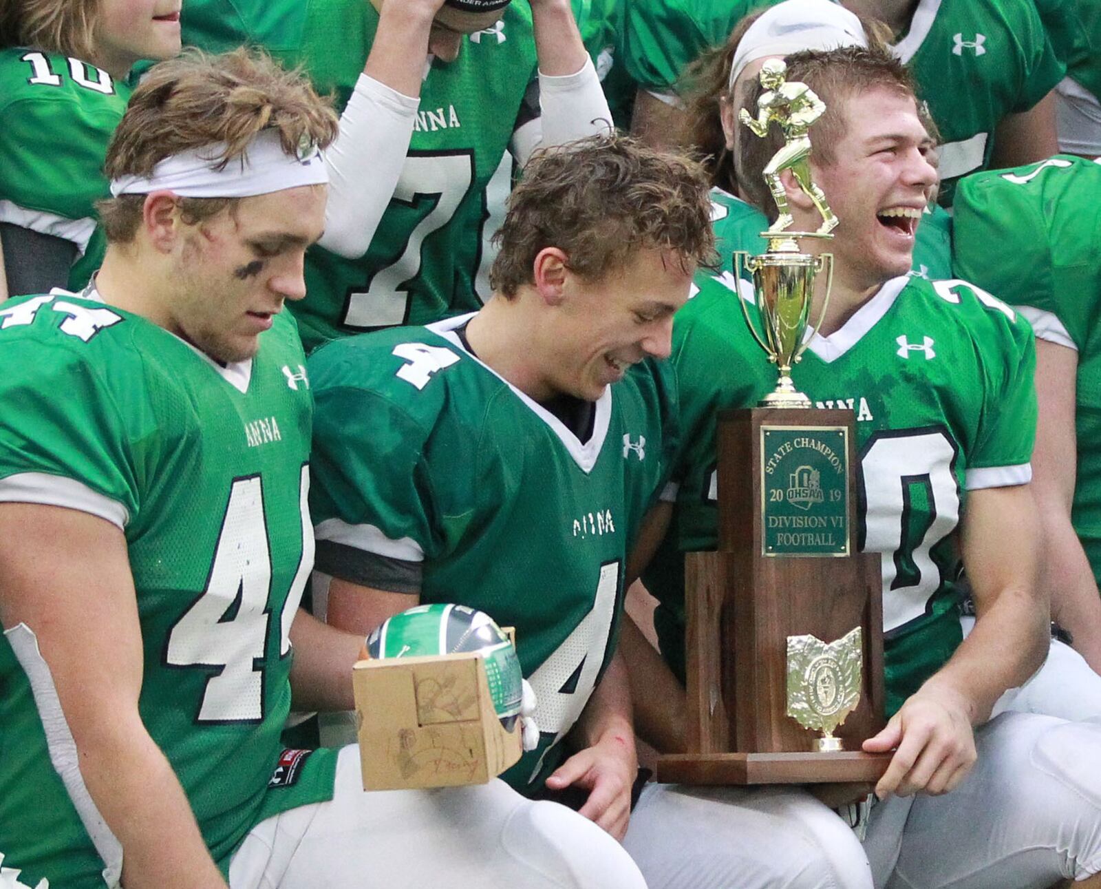 Malachi Minnich (left), Bart Bixler (middle) and Riley Huelskamp of Anna celebrate a 48-14 defeat of New Middletown Springfield 48-14 in the Division VI high school football state championship at Tom Benson Hall of Fame Stadium in Canton on Friday, Dec. 6, 2019. MARC PENDLETON / STAFF