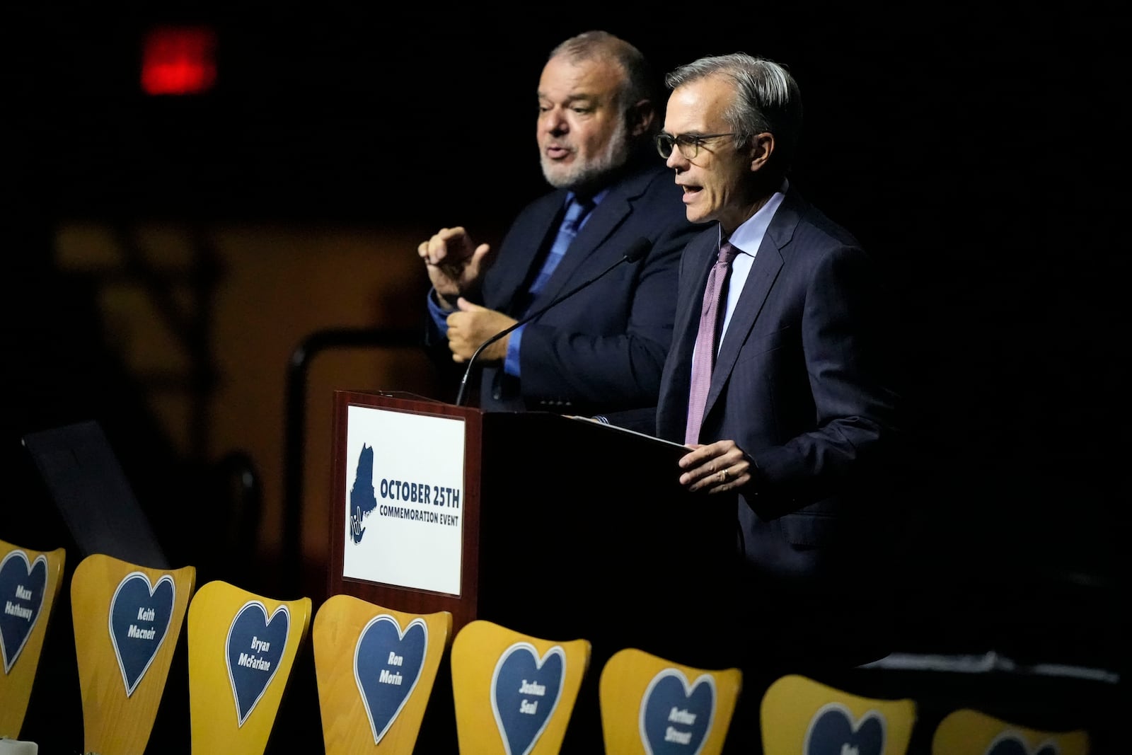 Tom Caron, right, master of ceremonies, speaks at a commemoration event to mark the one year anniversary of the mass shooting in Lewiston, Maine, Friday, Oct. 25, 2024. (AP Photo/Robert F. Bukaty)