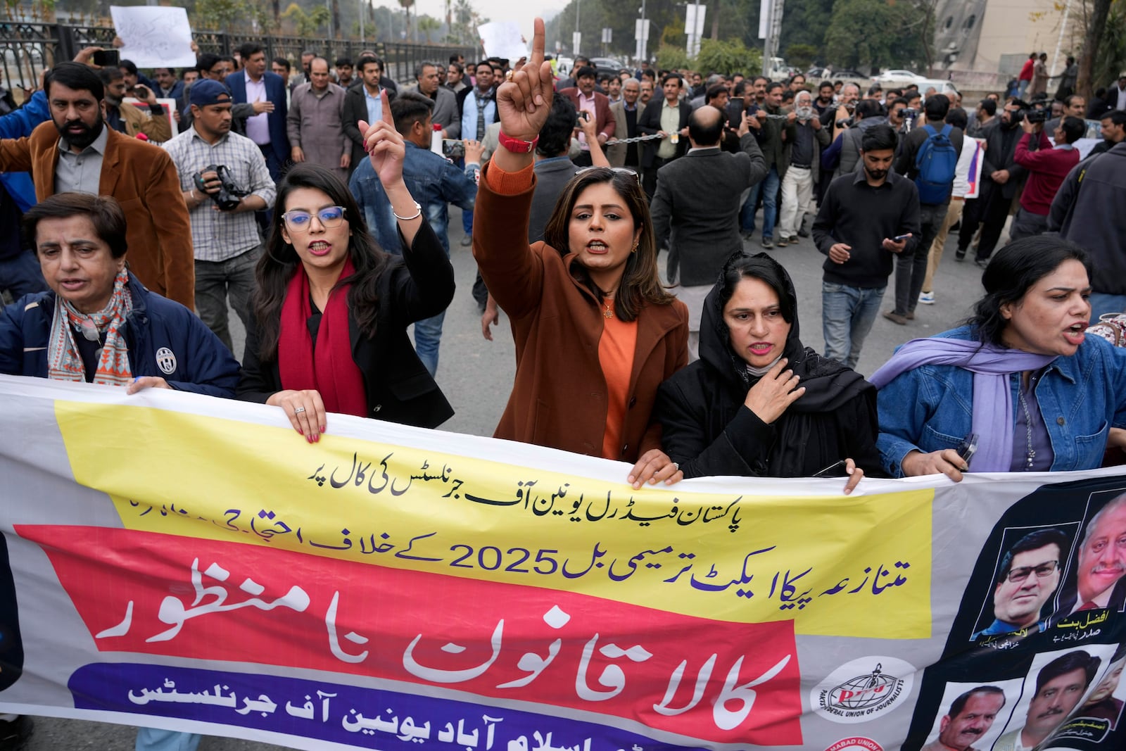 Journalists chant slogans during a protest rally in Islamabad, Pakistan, Tuesday, Jan. 28, 2025, to condemn a controversial 'Prevention of Electronic Crimes Act' bill passed by parliament that critics argue is designed to suppress freedom of speech. The banner reading as 'Reject Black Act'. (AP Photo/Anjum Naveed)