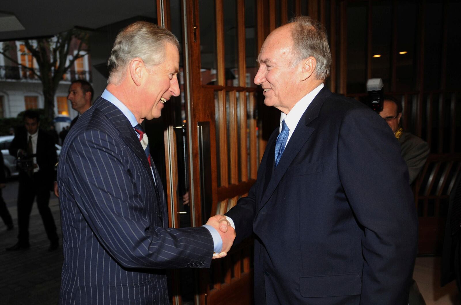 FILE - The Prince of Wales, now King Charles III, is greeted by the Aga Khan, right, during a visit to the Ismaili Centre to join a reception to help celebrate their 25th anniversary, in London, Nov. 18, 2010. (Anthony Devlin/PA via AP, File)