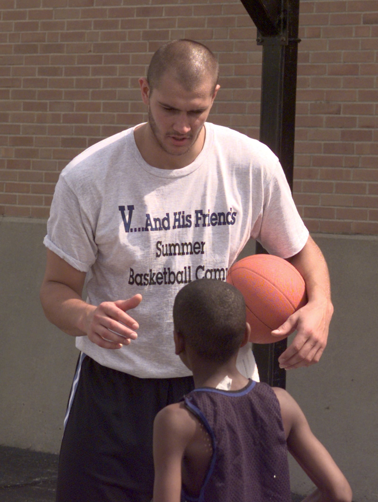 06/28/98; 6/27/98; Former Wright State basketball player and Cleveland Cavalier Vitaly Potapenko gives back to the community with the V and His Friends Basketball Camp held on the grounds ot East Dayton Boys and Girls Club in 1998. DDN FILE PHOTO