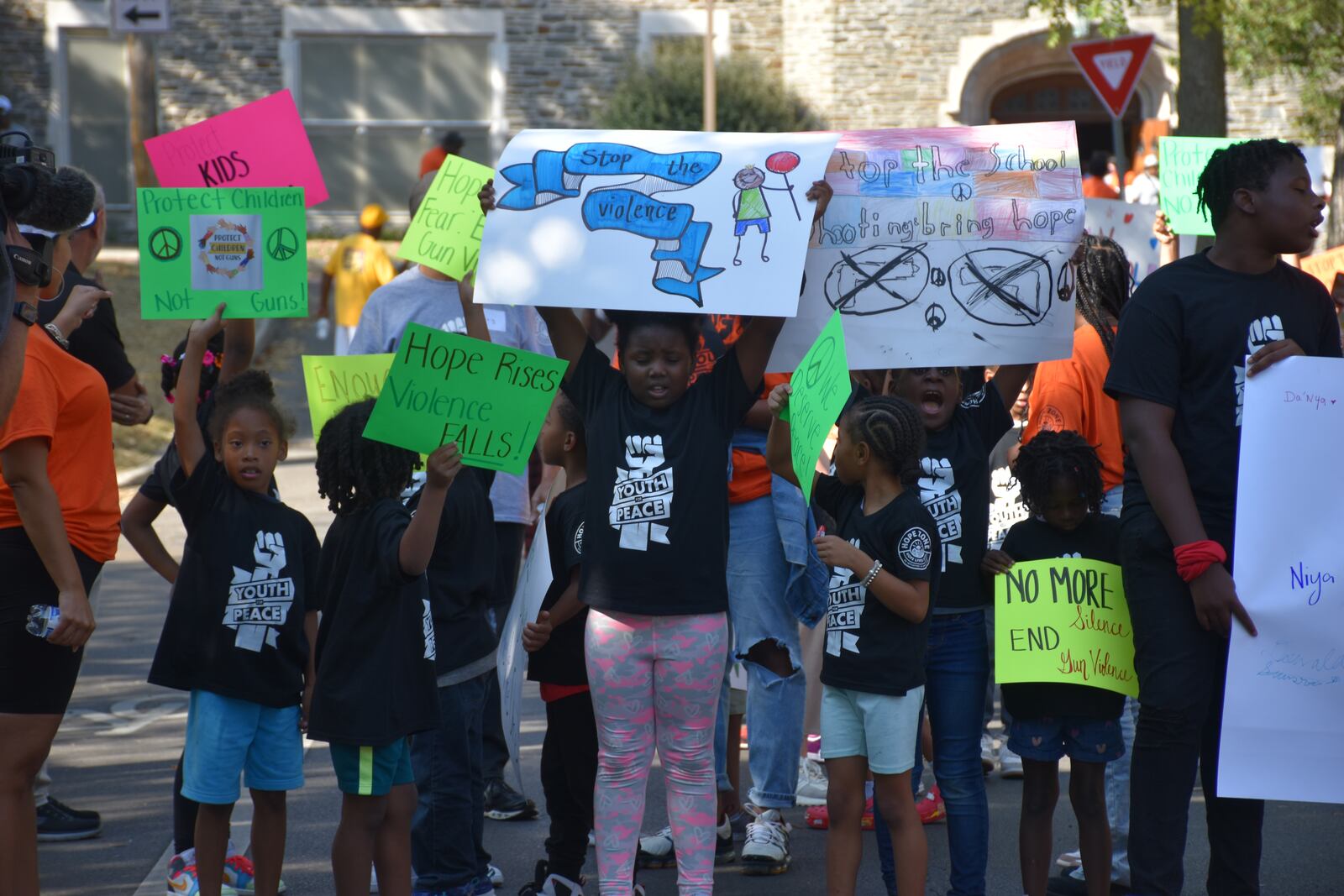 Kids, teens and adults marched down Broadway Street in northwest Dayton on Thursday as part of a peace march and rally in response to an increase in gun violence in the community. CORNELIUS FROLIK / STAFF