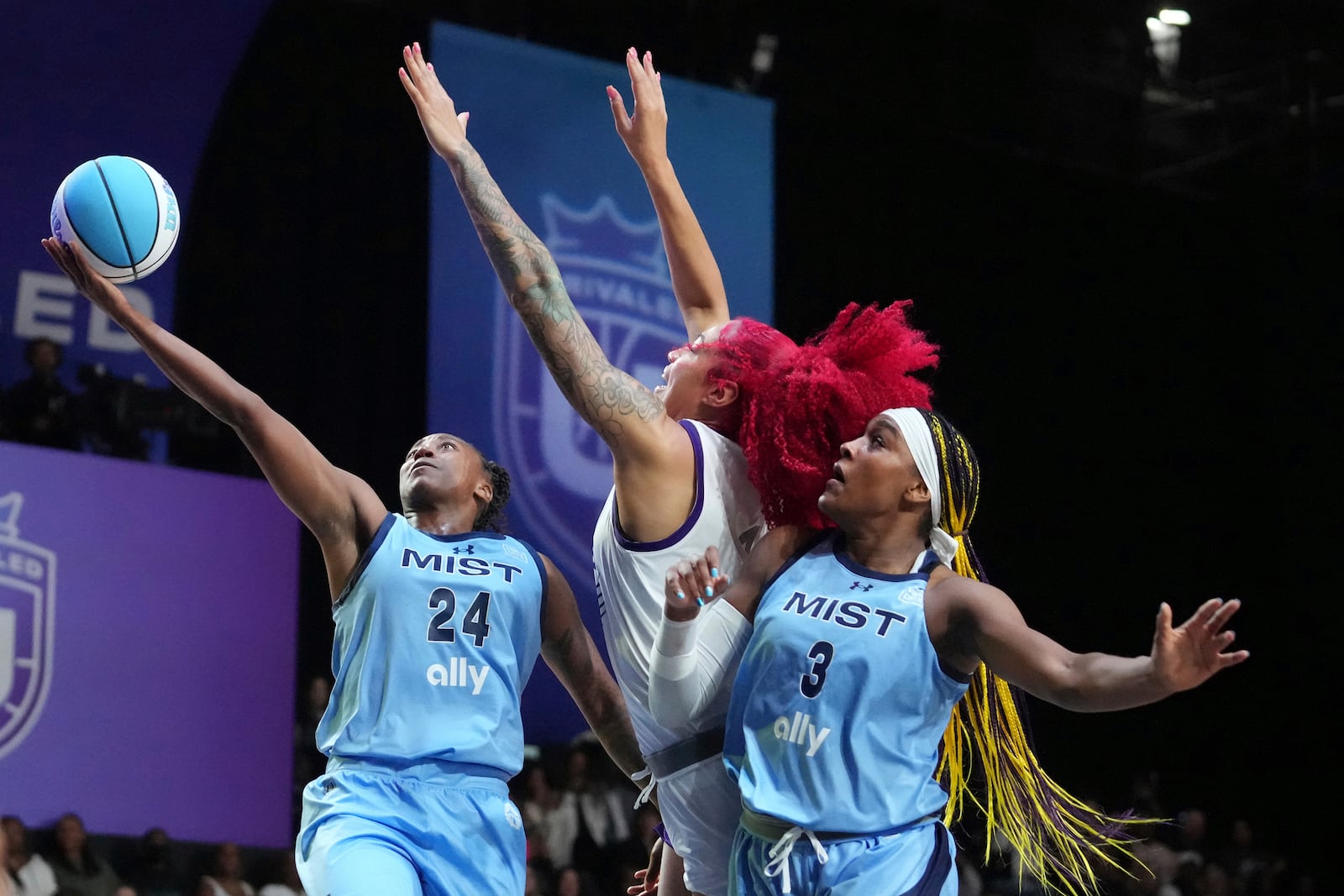 Mist's Jewell Loyd (24) aims to score against Lunar Owls Shakira Austin, center, during the first half during the inaugural Unrivaled 3-on-3 basketball game, Friday, Jan. 17, 2025, in Medley, Fla. (AP Photo/Marta Lavandier)