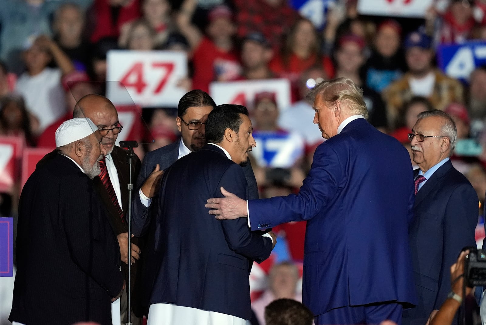 Republican presidential nominee former President Donald Trump, second right, greets local Muslim leaders during a campaign rally at the Suburban Collection Showplace, Saturday, Oct. 26, 2024 in Novi, Mich. (AP Photo/Carlos Osorio)