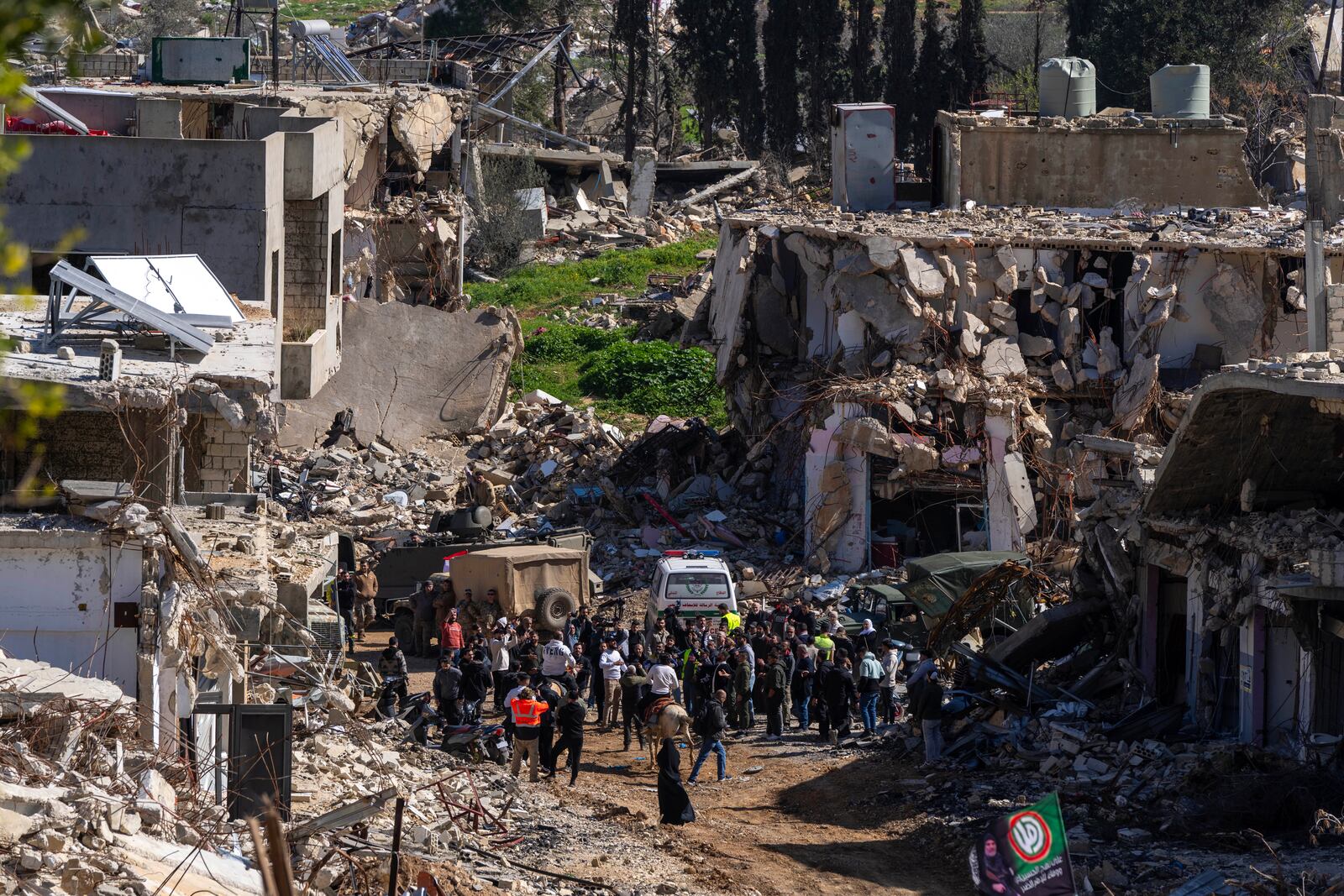 Lebanese people gather after they entered their destroyed hometown of Kfar Kila, southern Lebanon, Tuesday, Feb. 18, 2025. (AP Photo/Hassan Ammar)