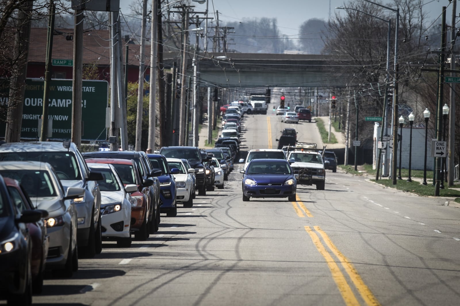 Hundreds of people lined up Wednesday afternoon for a food distribution at The Foodbank in Dayton., backing up traffic in the area. JIM NOELKER/STAFF