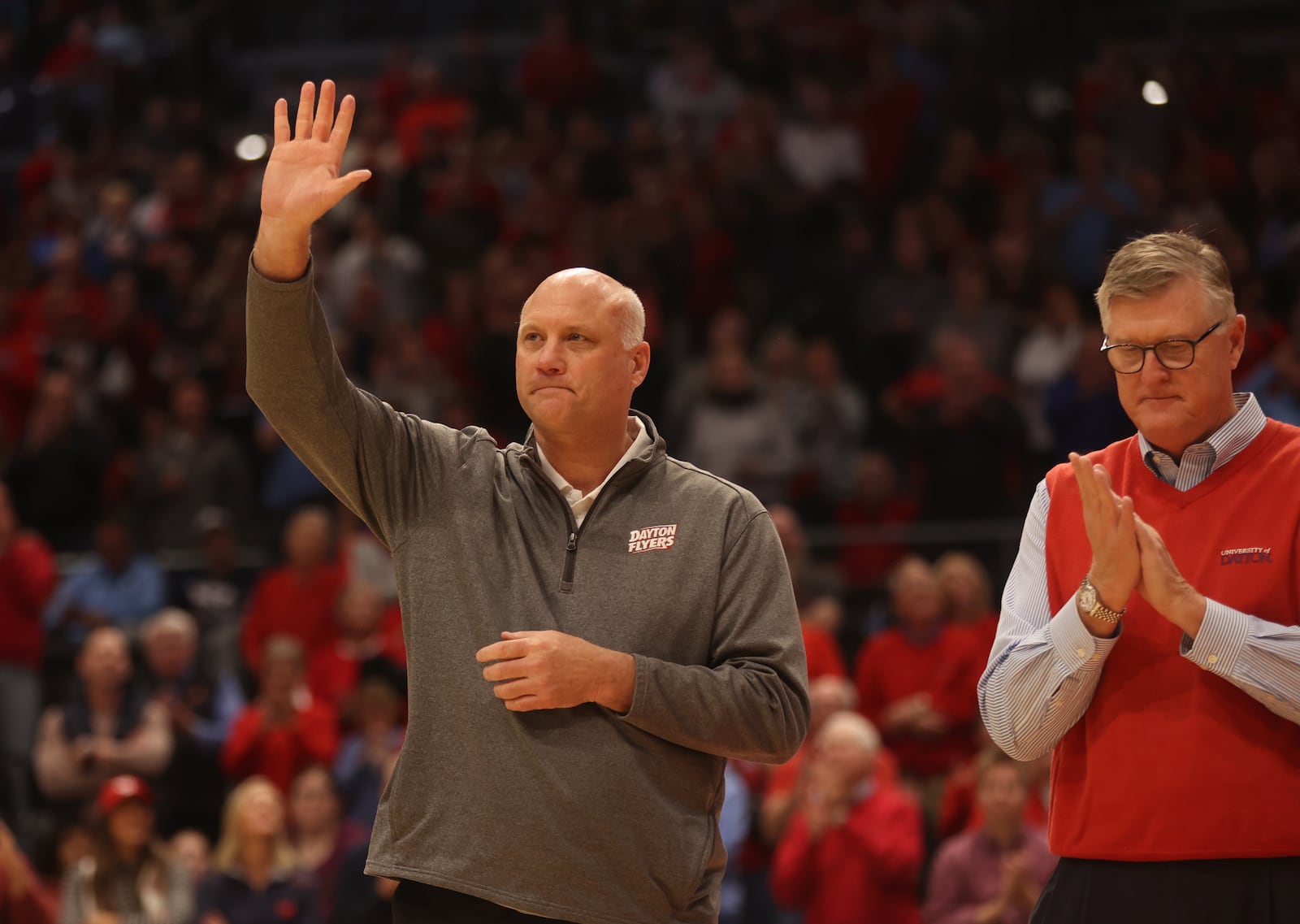 Damon Goodwin waves to the crowd during a ceremony honoring members of Dayton's 1984 Elite Eight team at halftime of a game against Grambling State on Saturday, Dec. 2, 2023, at UD Arena. David Jablonski/Staff