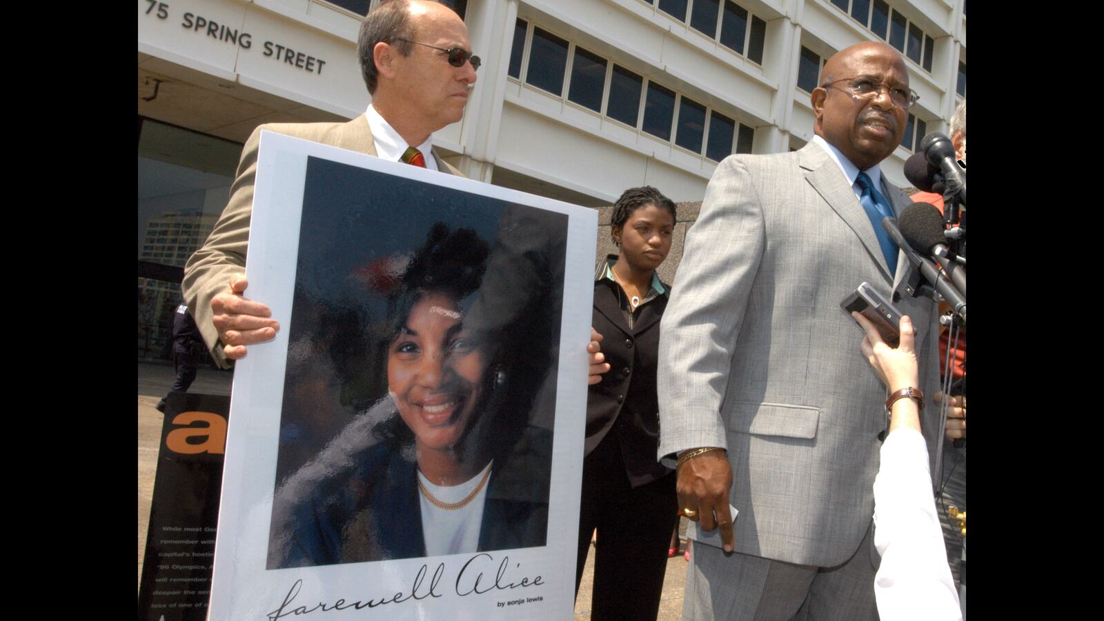 John Hawthorne, at right, widower of Alice Hawthorne, the woman killed in the July 27, 1996, Centennial Olympic Park bombing, and Alice's daughter, center, speak after Eric Robert Rudolph was sentenced in August 2005 to the last of four life sentences for the bombing at the 1996 Summer Olympic Games and three other bombings, including a bombing at an abortion clinic in Birmingham, Alabama, that killed an off-duty police officer.