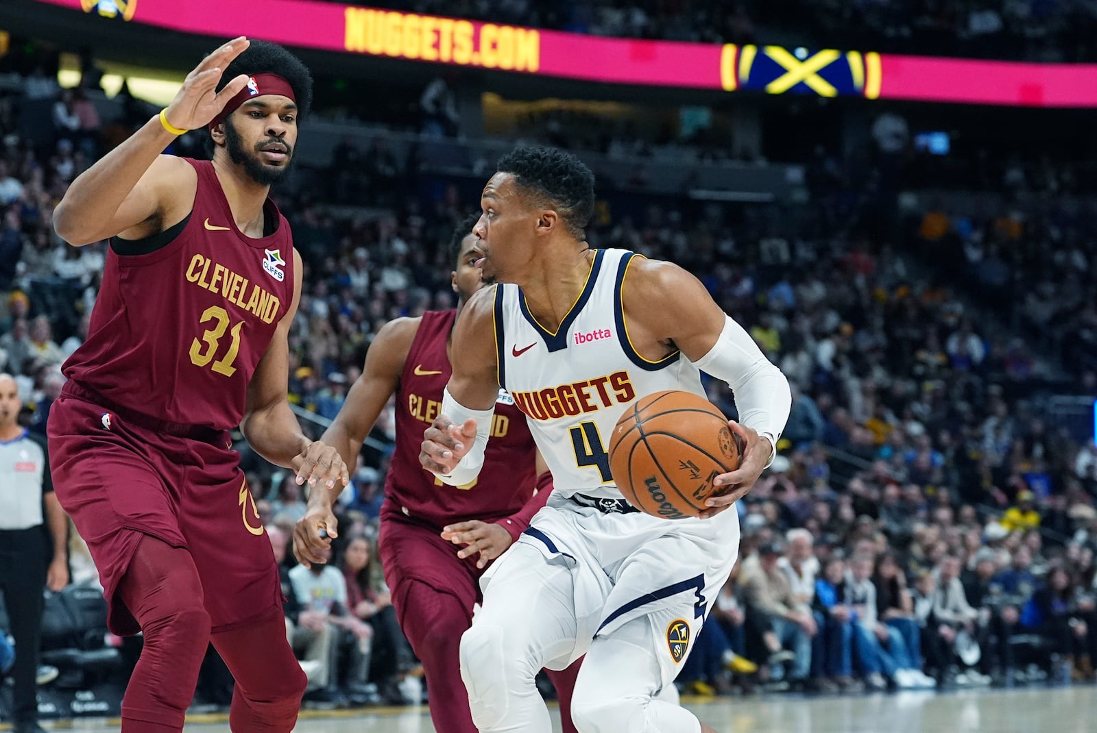 Denver Nuggets guard Russell Westbrook, right, drives to the basket as Cleveland Cavaliers center Jarrett Allen defends in the first half of an NBA basketball game Friday, Dec. 27, 2024, in Denver. (AP Photo/David Zalubowski)