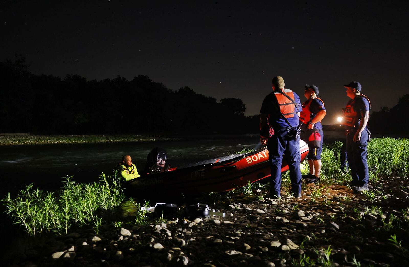 Middletown and Monroe rescue workers searched the Great Miami River north of Germantown Road bridge early Saturday morning on a report a person went into the water and needed rescue help. NICK GRAHAM/STAFF PHOTO