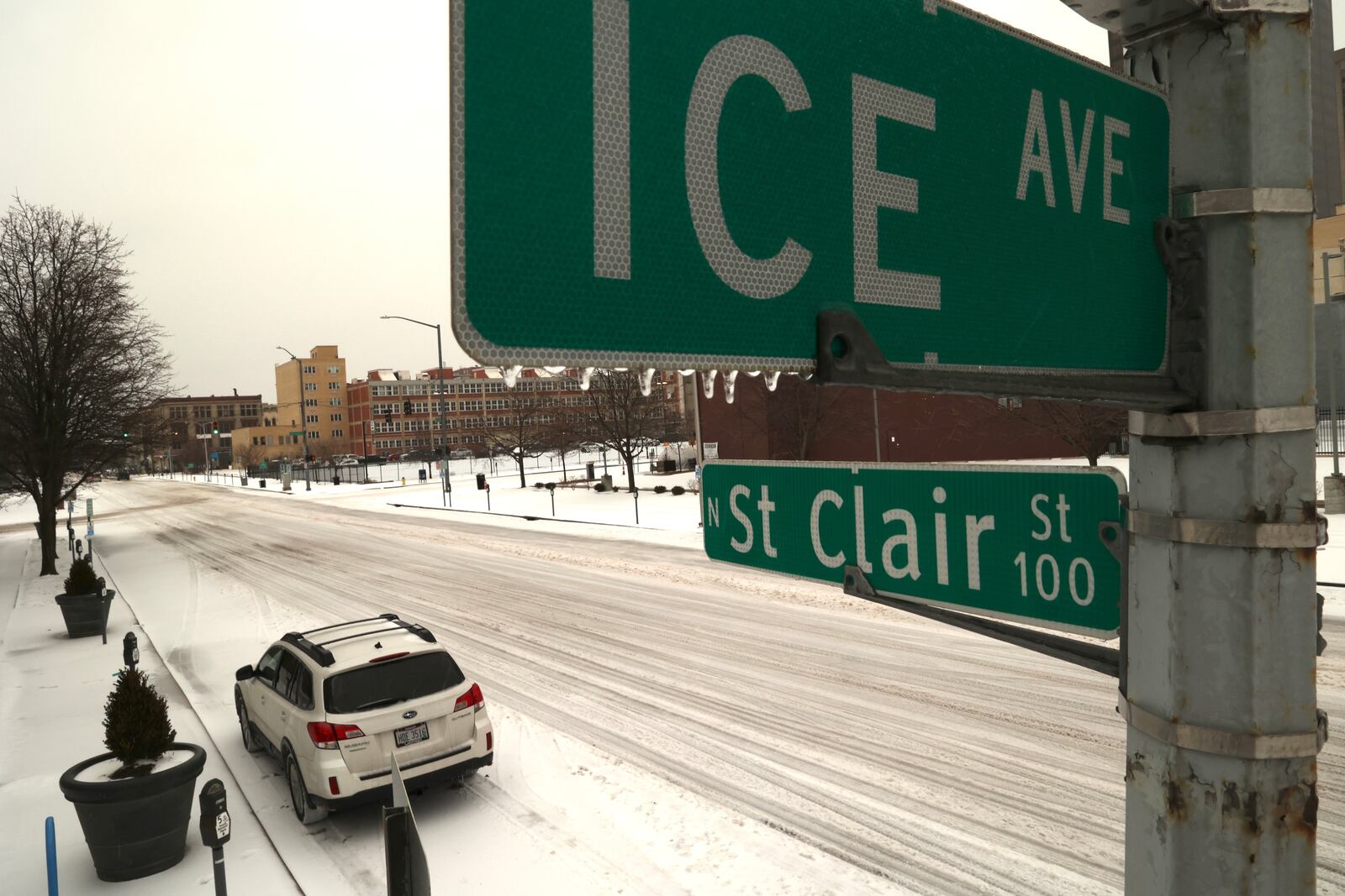 Icicles start to form on the ICE Avenue street sign at the intersection with St. Clair Street in Dayton Thursday. BILL LACKEY/STAFF