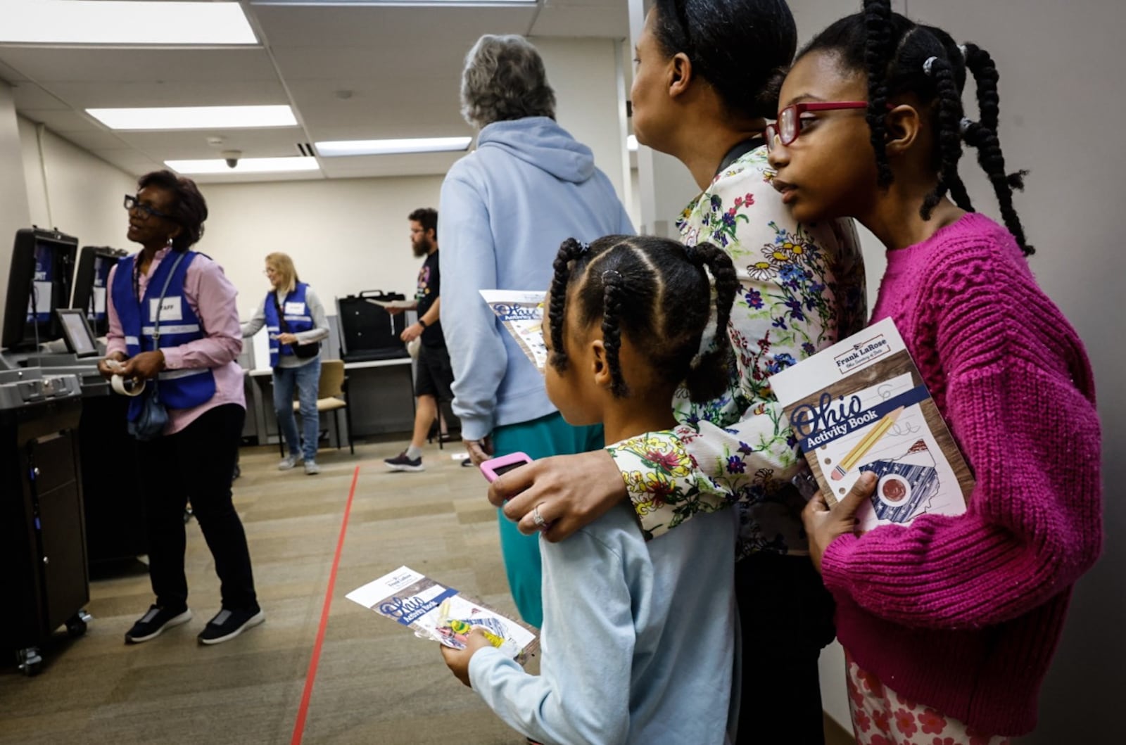 Keesha Melton along with her daughters Hannah and Kristiana stand in line to vote early at the Montgomery County Board of Elections Tuesday October 8, 2024. Jim Noelker/Staff