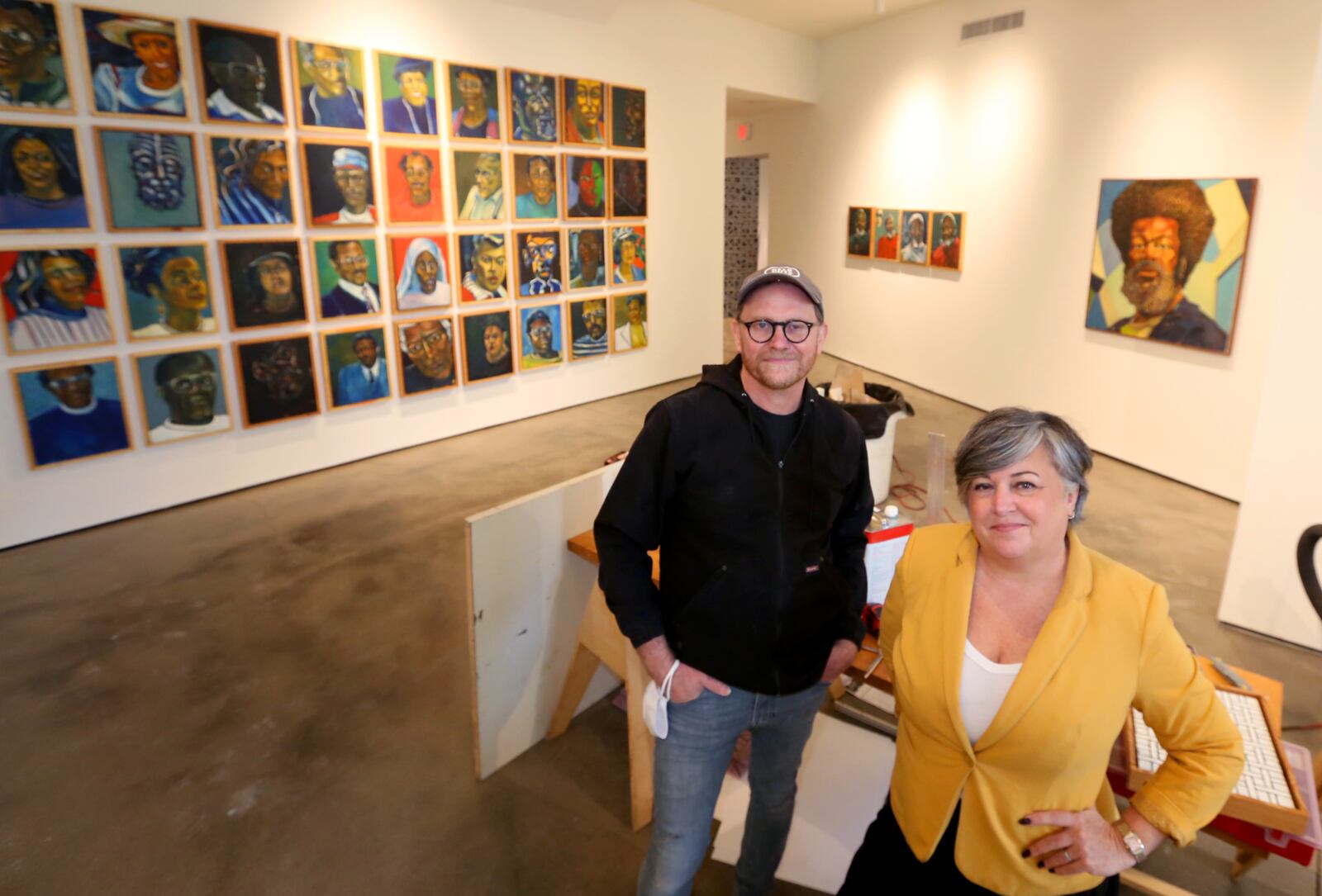 Michael Goodson, curator and director of programs and Eva Buttacavoli, executive director of The Contemporary, put the finishing touches on the art center's new home in the Dayton Arcade. LISA POWELL / STAFF