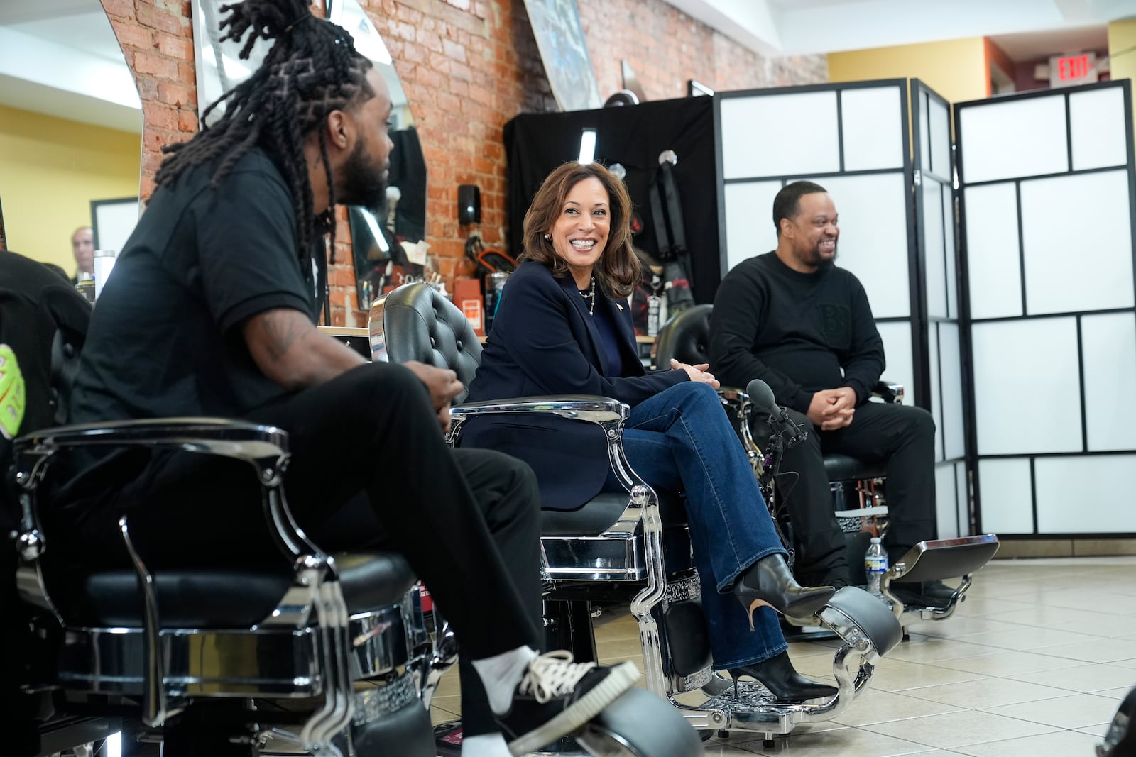 Democratic presidential nominee Vice President Kamala Harris, center, sits in conversation with Black men at Philly Cuts barbershop during a campaign stop, Sunday, Oct. 27, 2024, in Philadelphia. (AP Photo/Susan Walsh)