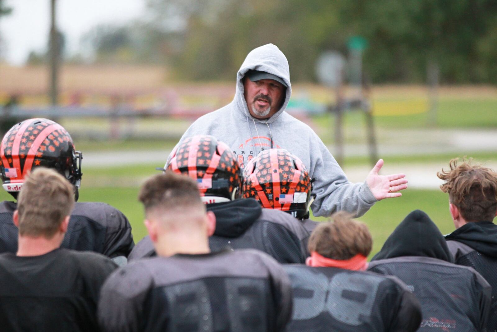 Arcanum head football coach Jason Schondelmyer huddles with the Trojans while preparing for a Week 8 high school football CCC showdown against Covington during practice on Wednesday, Oct. 16, 2019. MARC PENDLETON / STAFF