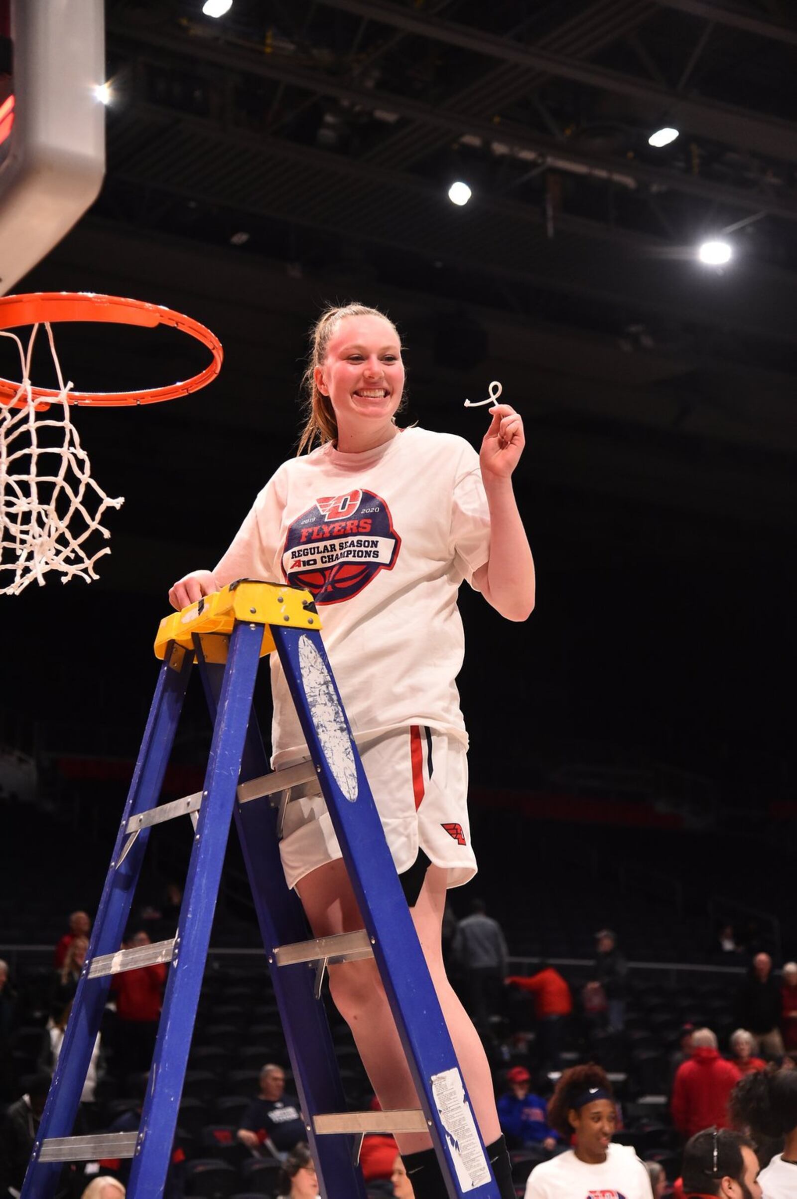 Dayton’s Erin Whalen cuts down a portion of the net after the Flyers’ A-10 clinching win over George Washington at UD Arena on Feb. 19, 2020. Erik Schelkun/CONTRIBUTED