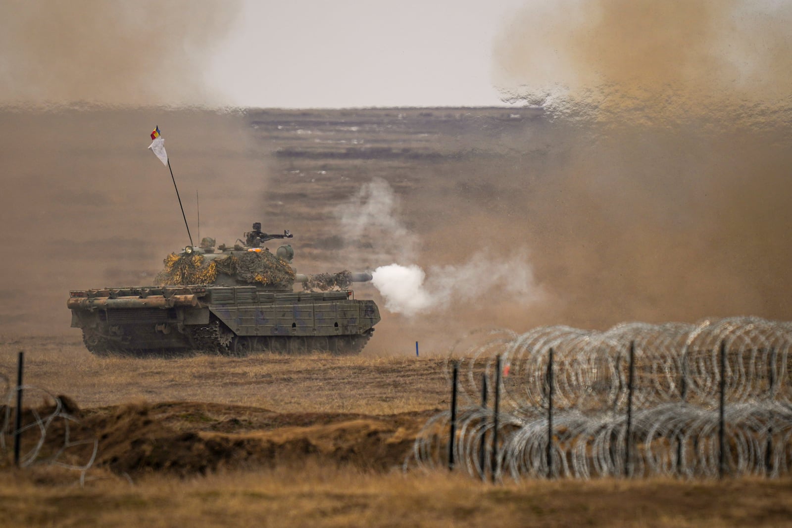 A tank fires during the Steadfast Dart 2025 exercise, involving some 10,000 troops in three different countries from nine nations and represent the largest NATO operation planned this year, at a training range in Smardan, eastern Romania, Wednesday, Feb. 19, 2025. (AP Photo/Vadim Ghirda)