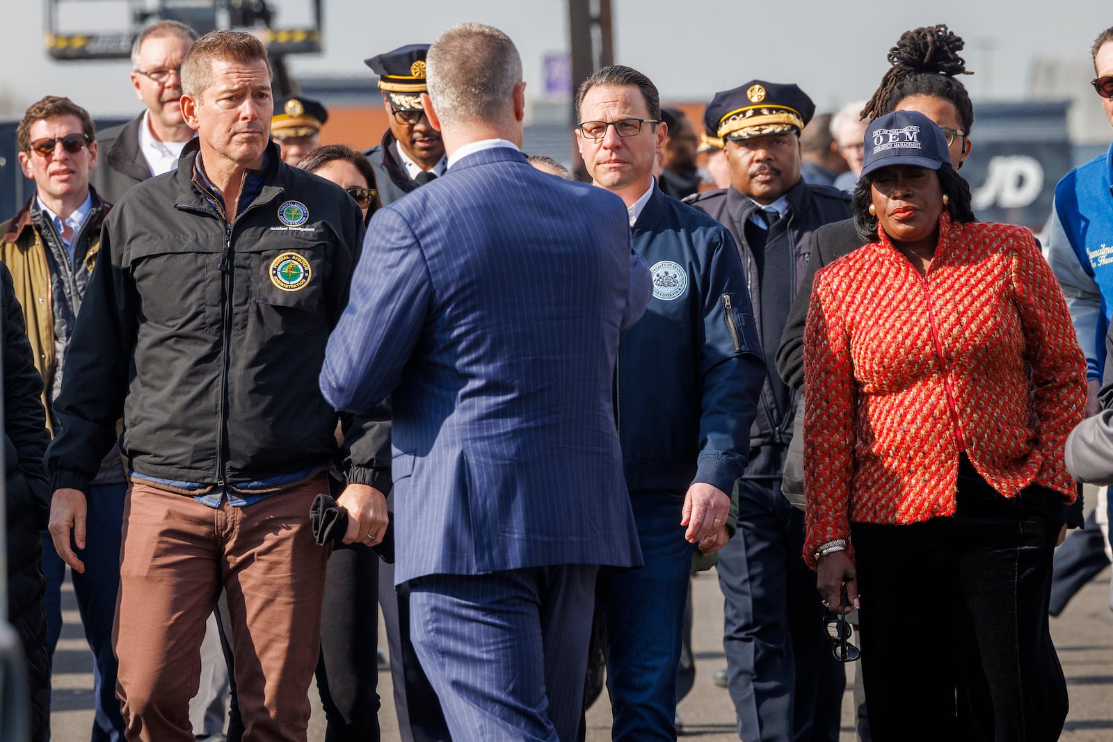 From left; United States Secretary of Transportation Sean Patrick Duffy, Pennsylvania Governor Josh Shapiro and Philadelphia Mayor Cherelle Parker along with Philadelphia Managing Director Adam Thiel walk through the scene of a fatal medical jet crash Monday, Feb. 3, 2025, in Philadelphia. (Alejandro A. Alvarez/The Philadelphia Inquirer via AP)