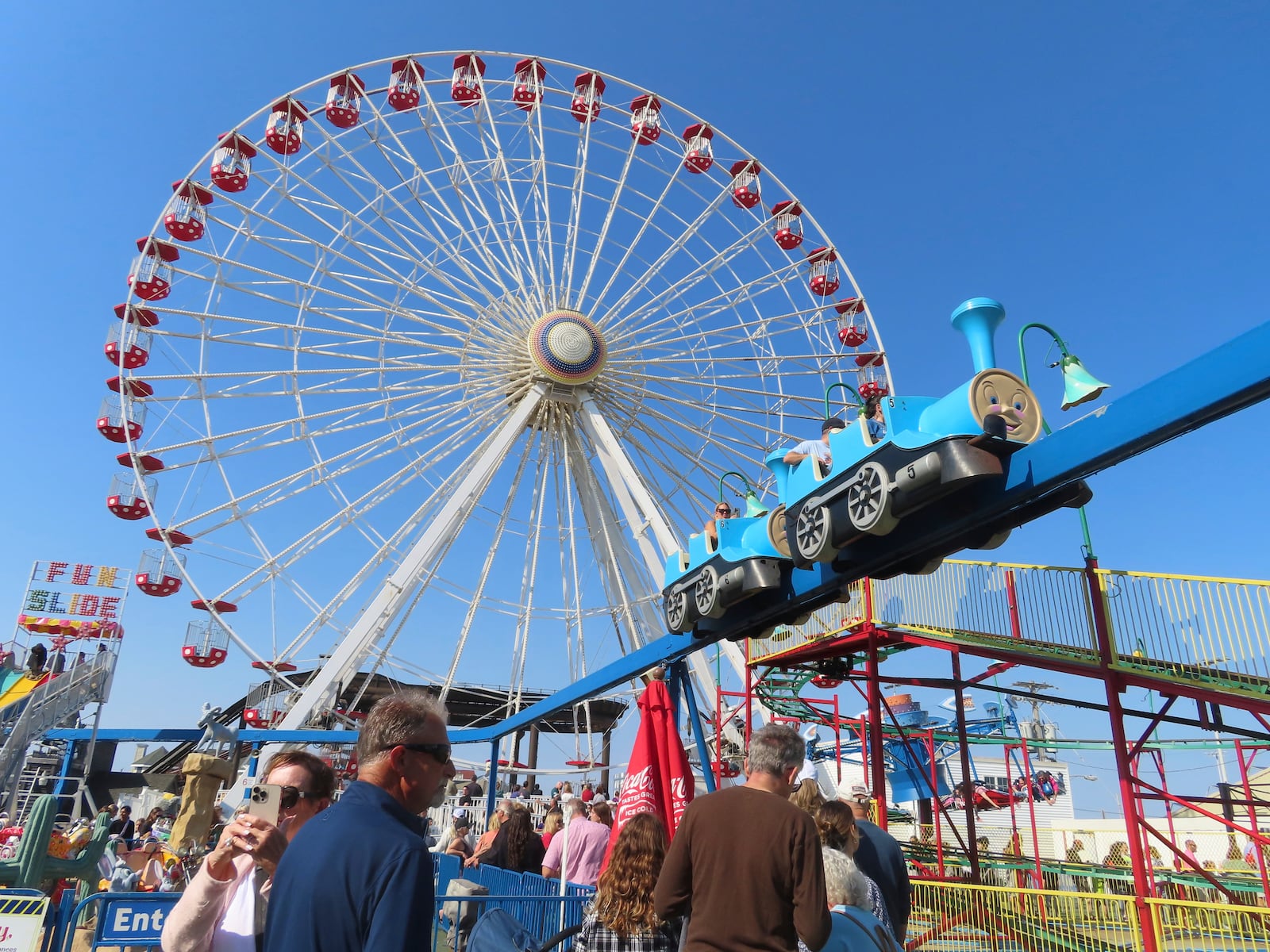 People wait in line to board rides at Gillian's Wonderland on the Ocean City N.J. boardwalk on Oct. 13, 2024, the popular amusement park's final day of operation before shutting down for good. (AP Photo/Wayne Parry)