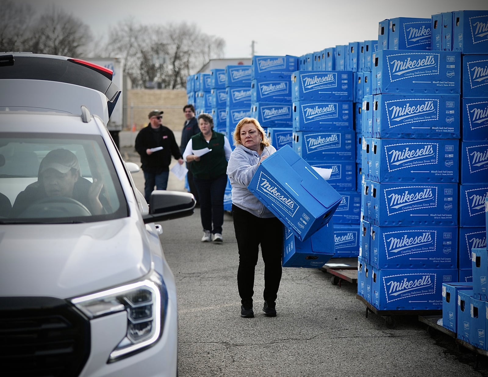 People waiting in line for over an hour to get their last chance to buy Mikesells potato chips at their facility on Leo Street Thursday morning March 2, 2023. MARSHALL GORBY \STAFF