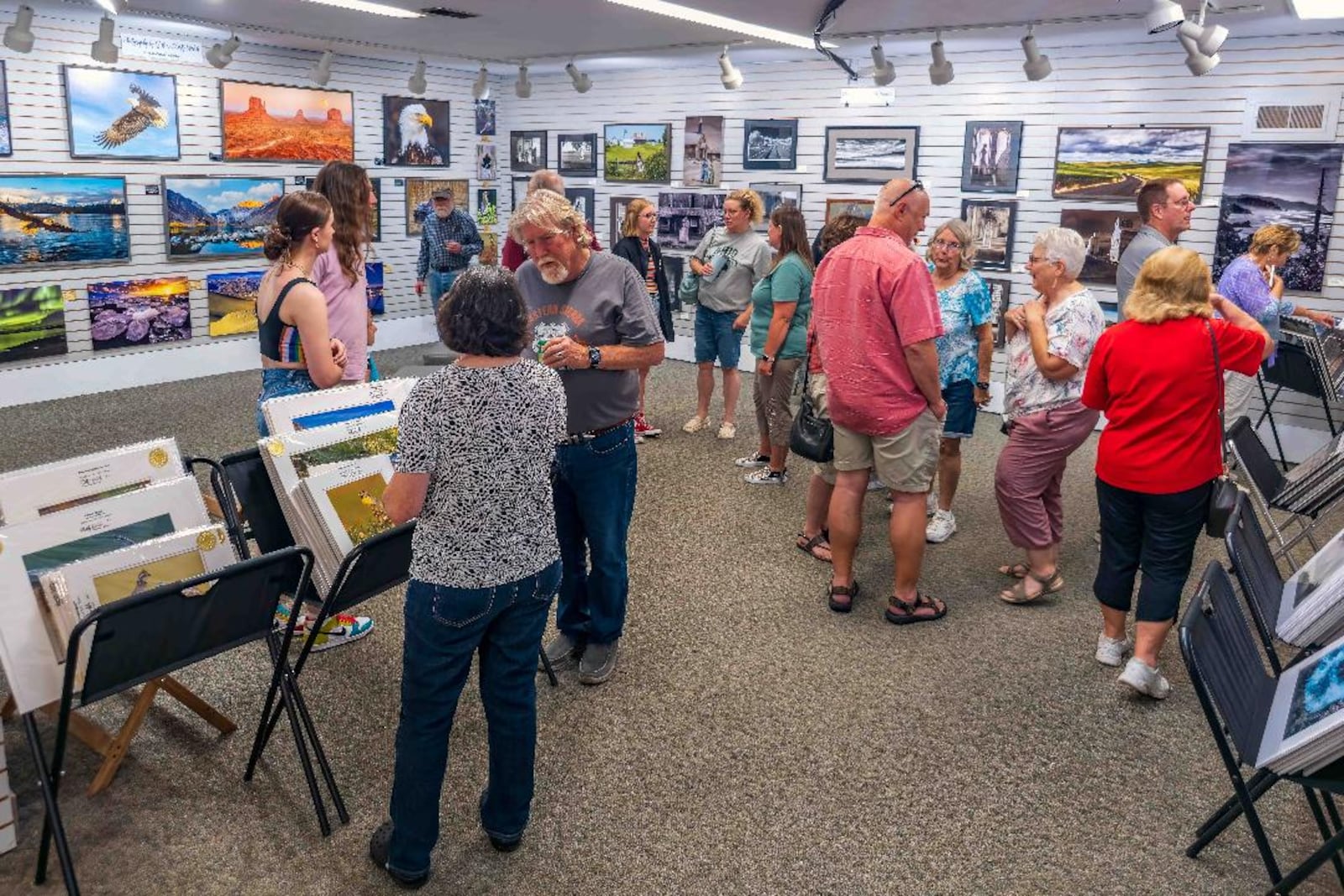 Patrons gather for an art show at Sugarcreek Photography Gallery in Bellbrook. PHOTO BY JEFF SMITH/ART OF FROZEN TIME