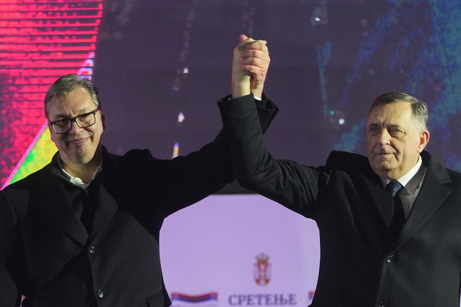 Serbian President Aleksandar Vucic, left, poses with Bosnian Serb political leader Milorad Dodik during a rally marking the country's Statehood Day in Sremska Mitrovica, Serbia, Saturday, Feb. 15, 2025. (AP Photo/Antonio Ahel)