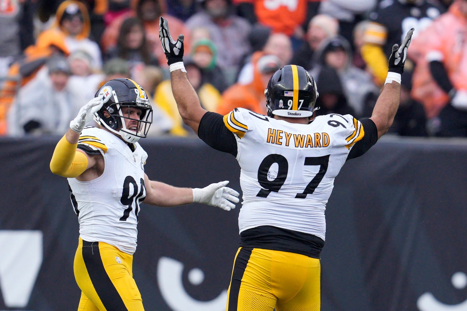 Pittsburgh Steelers defensive tackle Cameron Heyward (97) and T.J. Watt (90) celebrate sacking Cincinnati Bengals quarterback Jake Browning during the second half of an NFL football game in Cincinnati, Sunday, Nov. 26, 2023. (AP Photo/Jeffrey Dean)