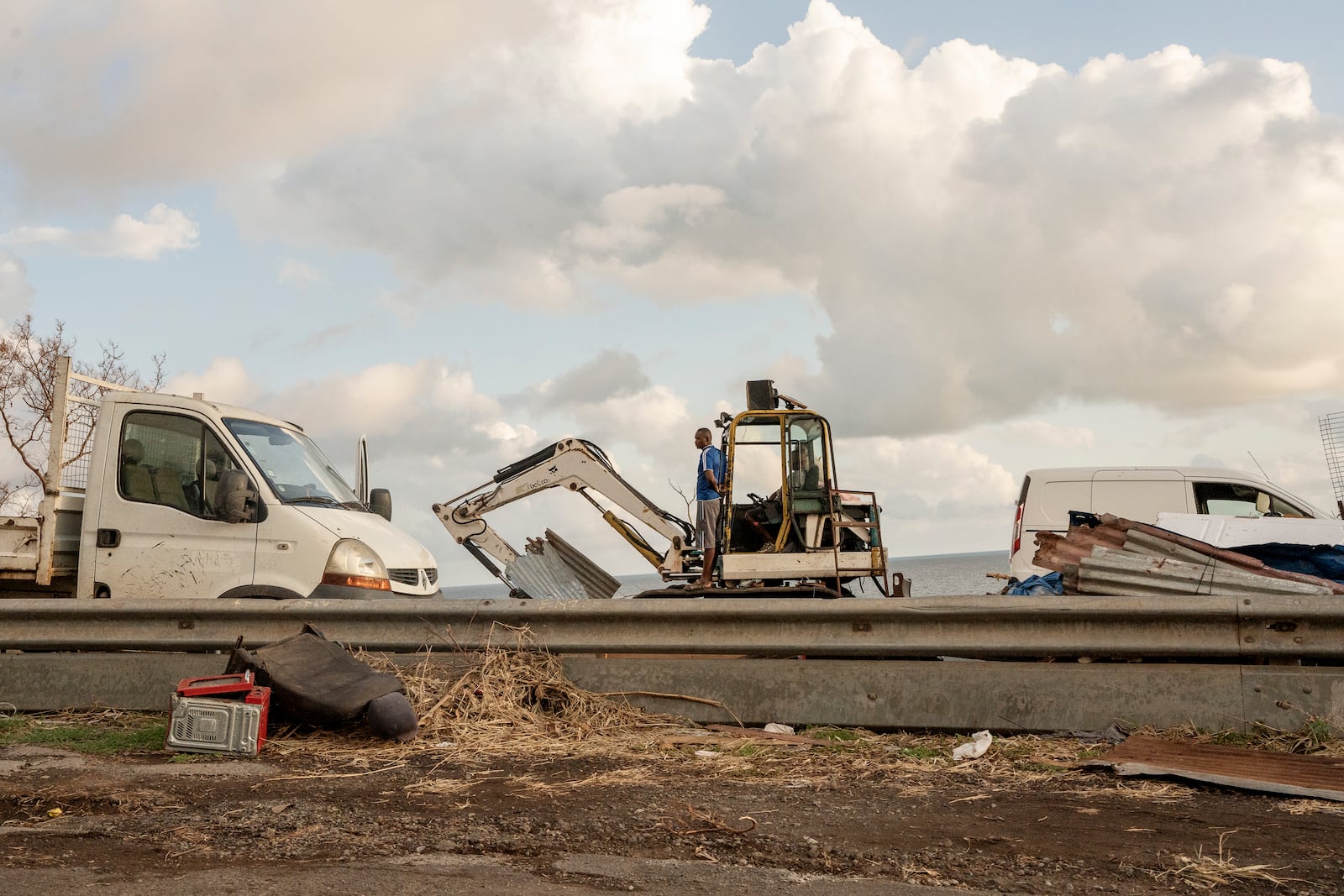 Construction crew clear debris from the area near Longoni port, Mayotte, Friday, Dec. 20, 2024. (AP Photo/Adrienne Surprenant)