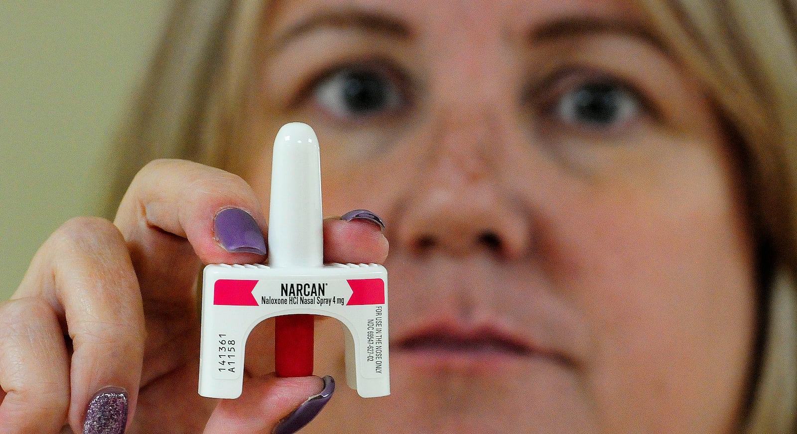 Dawn Schwartz, project Manager for the Community Overdose Action Team, holds up the Narcan, Nalexone HCI Nasal Spray. MARSHALL GORBY\STAFF