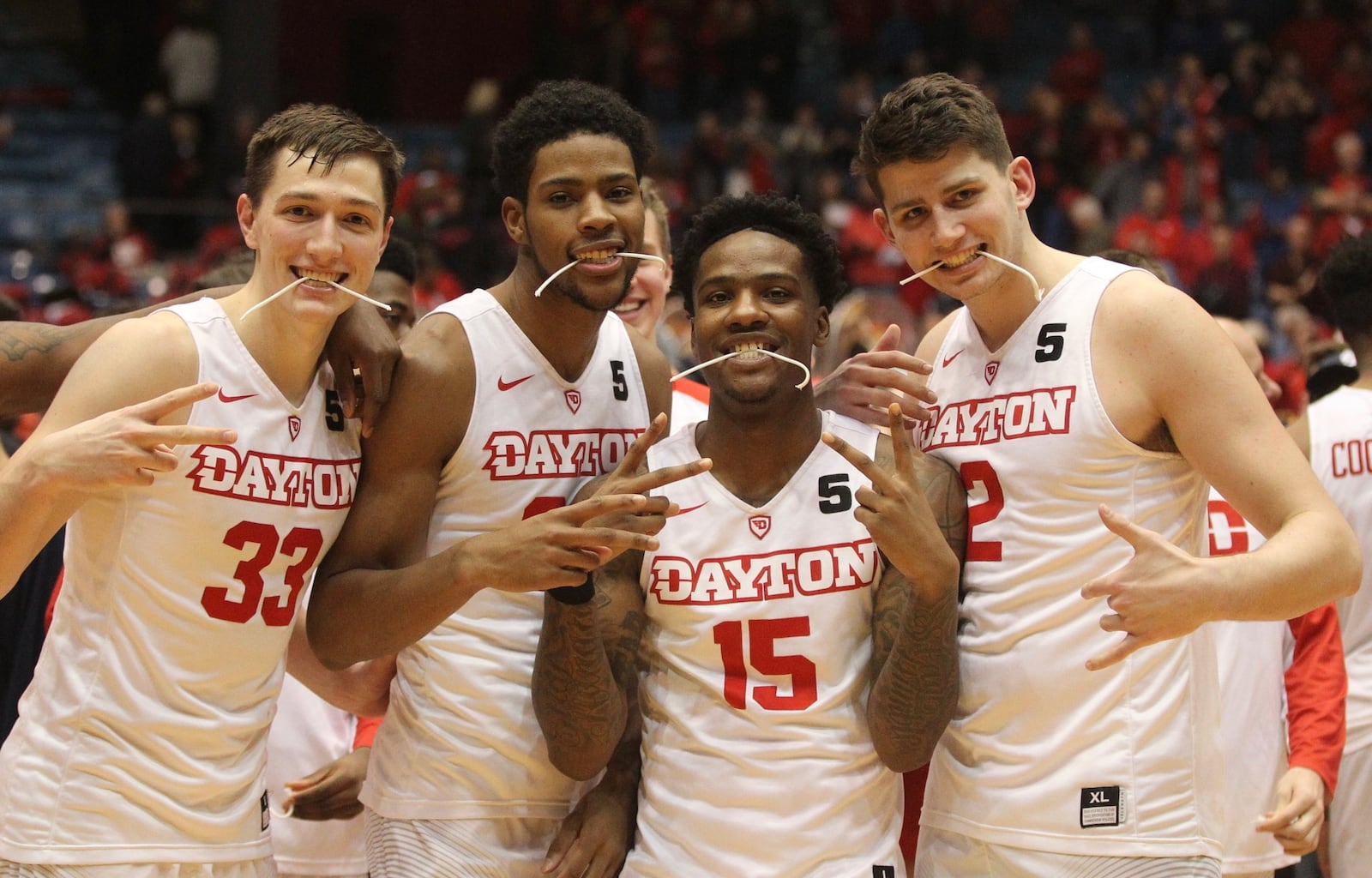 Dayton sophomores Ryan Mikesell, Xeyrius Williams, John Crosby and Sam Miller pose for a photo after a victory against Virginia Commonwealth on Wednesday, March 1, 2017, at UD Arena. David Jablonski/Staff