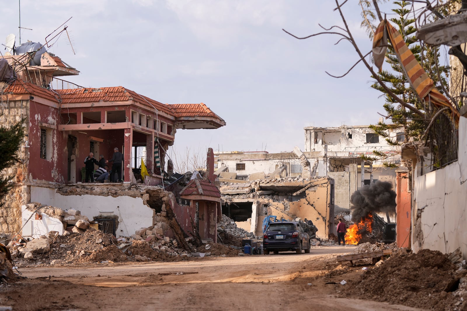 Lebanese citizens check the destruction on their house caused by the Israeli air and ground offensive, in their hometown Khiam, southern Lebanon, Monday, Feb. 17, 2025. (AP Photo/Hassan Ammar)