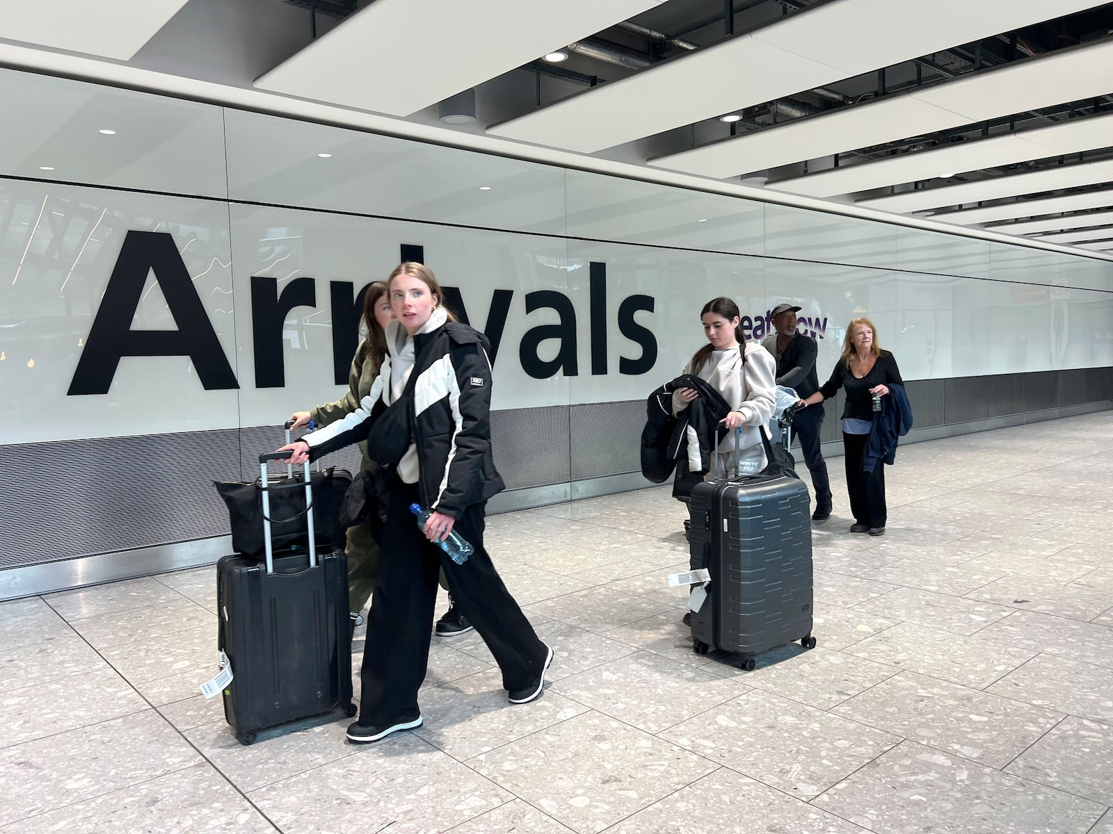 Passengers in the arrivals hall at Heathrow Terminal 5 in London, Saturday March 22, 2025, after flights resumed at the airport. (Maja Smiejkowska/PA via AP)