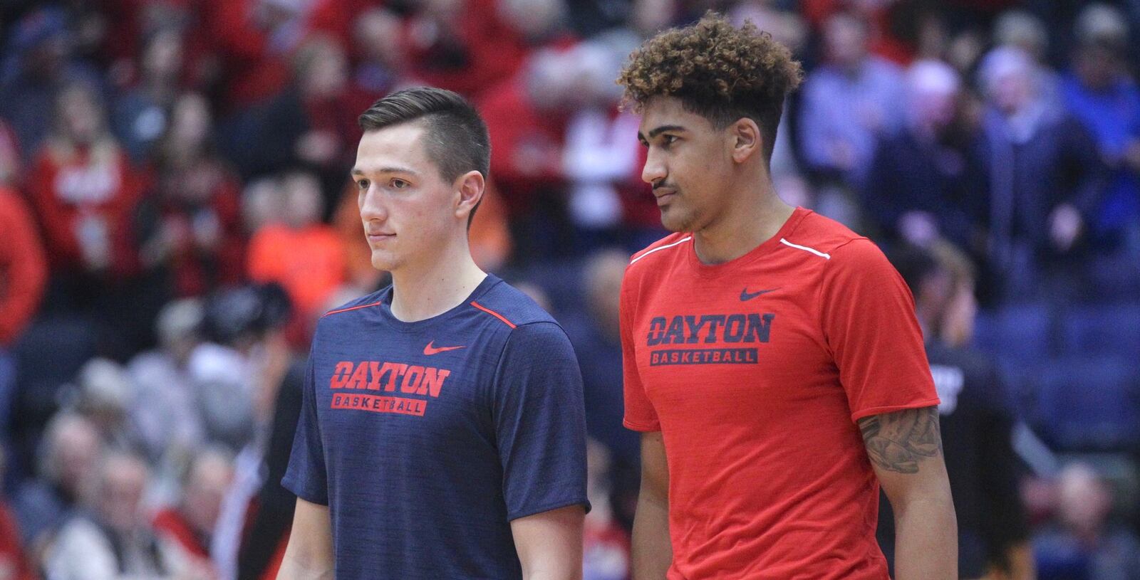 Dayton’s Ryan Mikesell and Obadiah Toppin watch the team warm up before a game against Tennessee Tech on Dec. 6, 2017, at UD Arena. David Jablonski/Staff