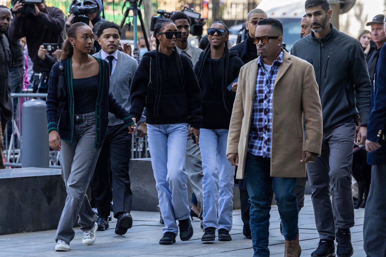 D'Lila Combs and Jessie Combs, center, twin daughters of Sean "Diddy Combs, arrive at Manhattan federal court, Thursday, Oct. 10 2024, in New York. (AP Photo/Yuki Iwamura)