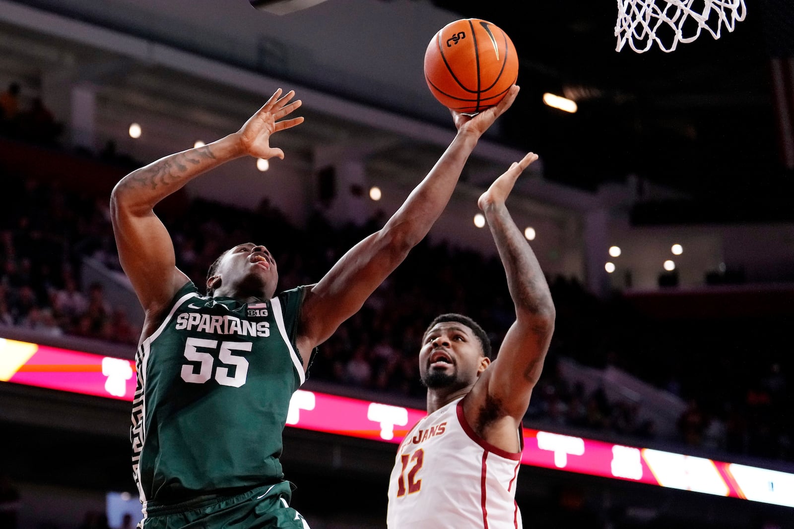 Michigan State forward Coen Carr, left, shoots as Southern California forward Rashaun Agee defends during the first half of an NCAA college basketball game, Saturday, Feb. 1, 2025, in Los Angeles. (AP Photo/Mark J. Terrill)