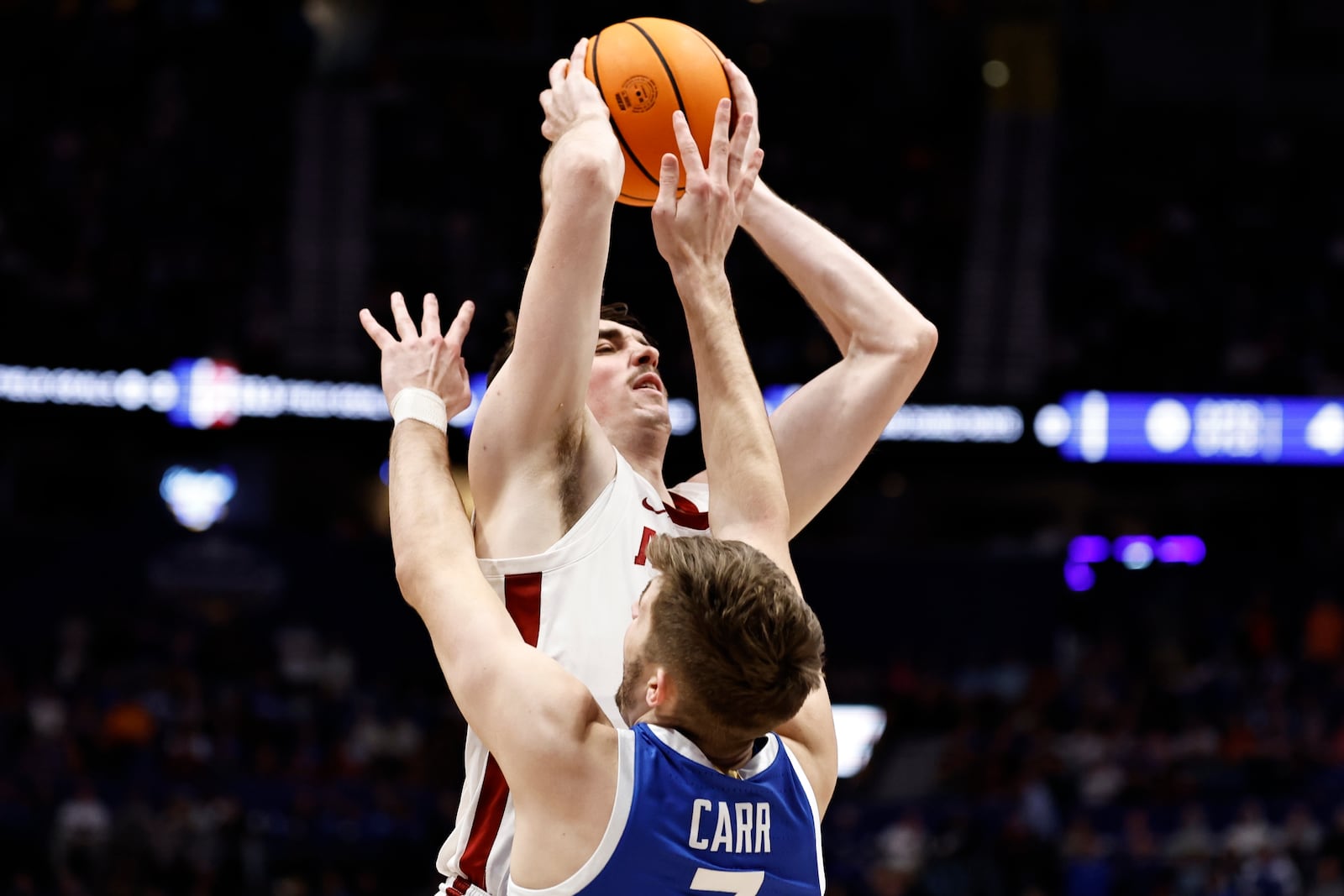 Alabama forward Grant Nelson (4) shoots against Kentucky forward Andrew Carr (7) during the first half of an NCAA college basketball game in the quarterfinal round of the Southeastern Conference tournament, Friday, March 14, 2025, in Nashville, Tenn. (AP Photo/Wade Payne)