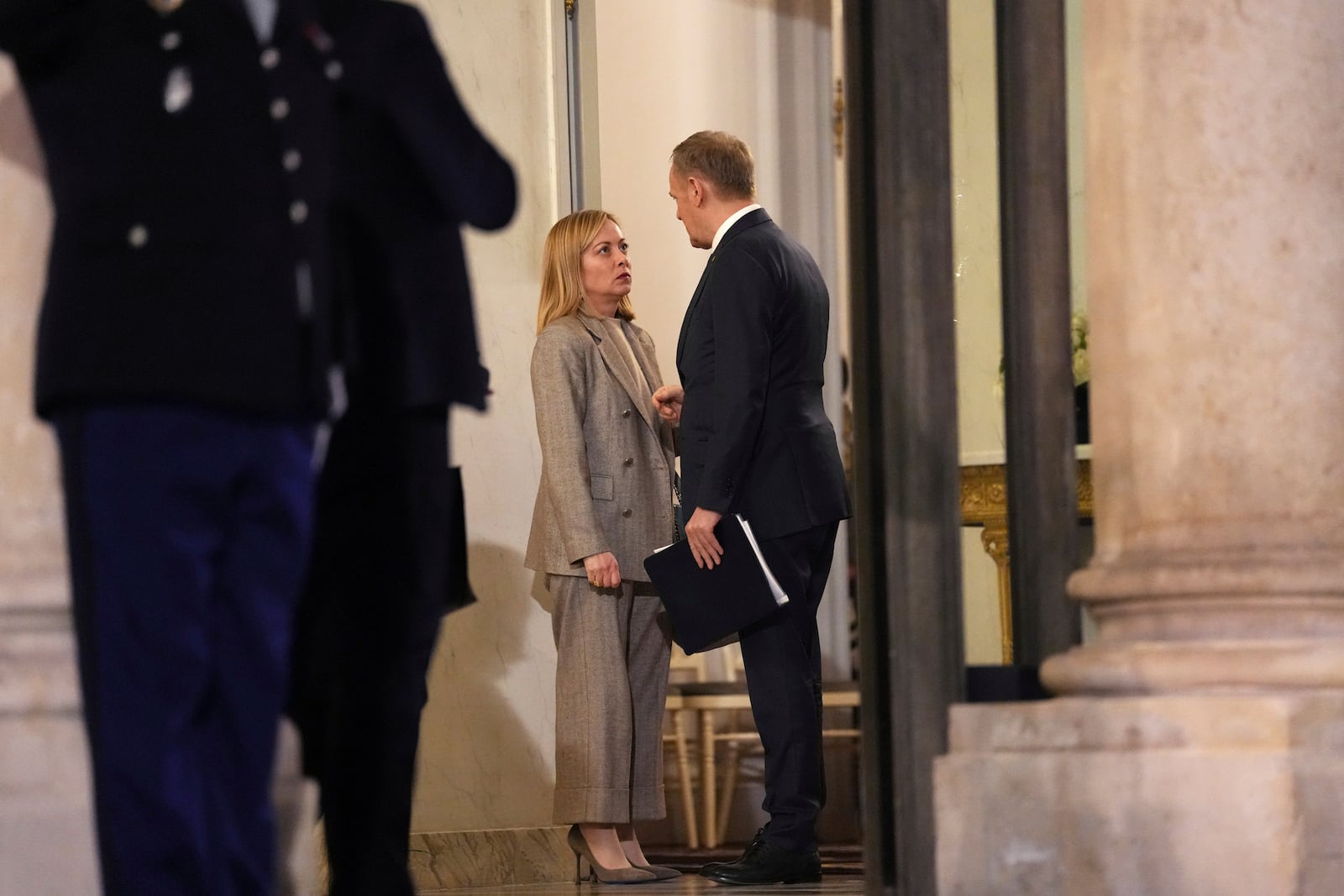 Poland's Prime Minister Donald Tusk, right, speaks with Italy's Prime Minister Giorgia Meloni as they prepare to leave the Elysee Palace, after an informal meeting of leaders from key European Union nations and the United Kingdom, in Paris, Monday, Feb. 17, 2025. (AP Photo/Aurelien Morissard)