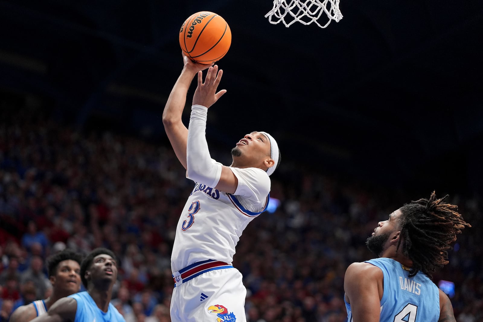 Kansas guard Dajuan Harris Jr. (3) puts up a shot during the first half of an NCAA college basketball game against North Carolina Friday, Nov. 8, 2024, in Lawrence, Kan. (AP Photo/Charlie Riedel)