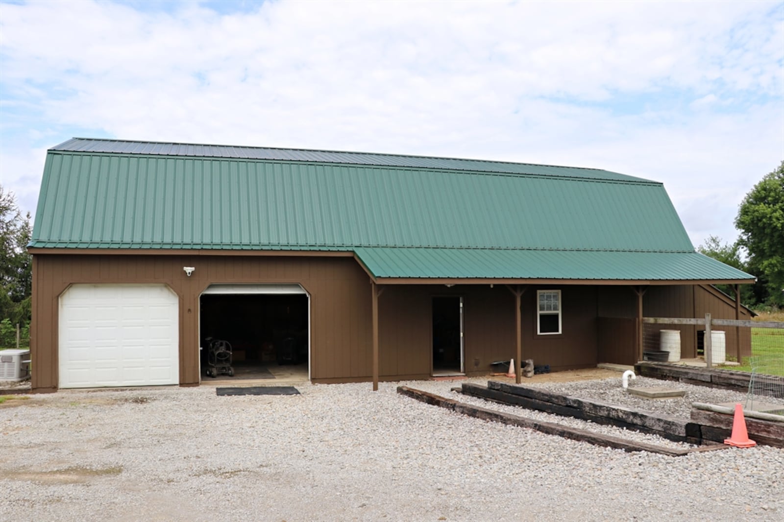 The home at 1150 Roxanne New Burlington Road is on a former alpaca farm and has fenced pastures with barn access. The 30-by-60-foot barn has a concrete floor, a metal roof, floored second floor, two overhead bay doors, two separate rooms for workshop space and office space and covered stalls and hay bins. The barn has a separate electric and water source. KATHY TYLER/CONTRIBUTED