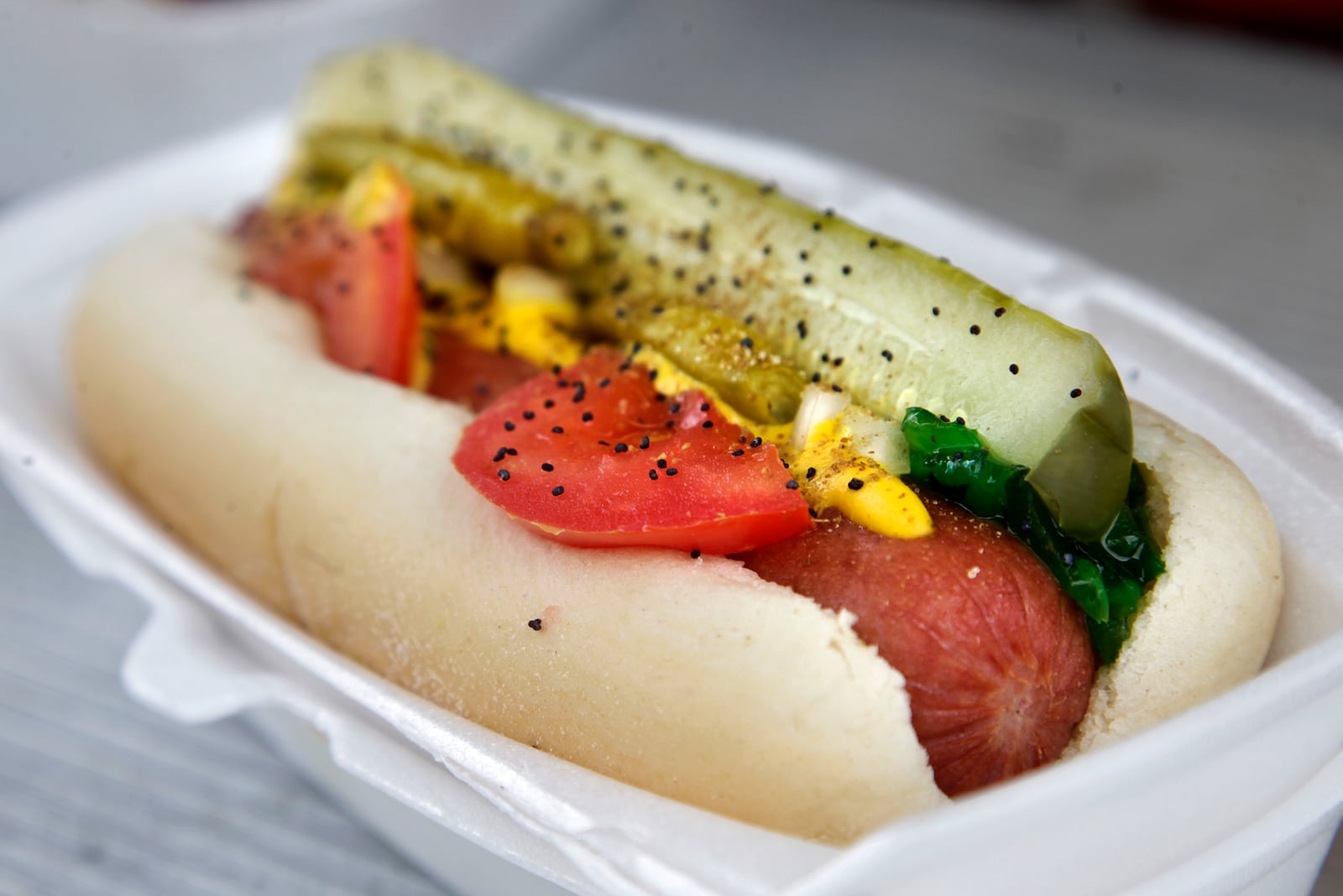 The Clark & Addison specialty hot dog at Underdogs Mobile is Chicago style with a dill pickle spear, tomato, relish, onion, mustard, poppy seeds, celery salt and sport pepper. LISA POWELL / STAFF