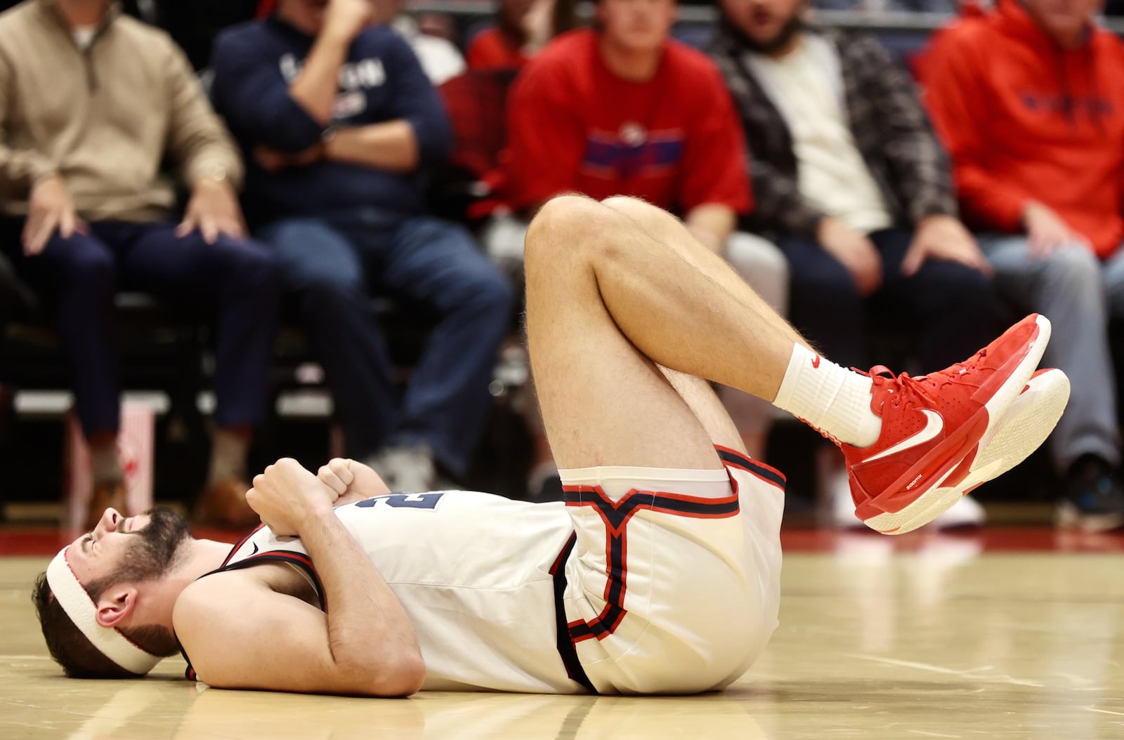 Dayton's Jacob Conner grimaces after turning his ankle against New Mexico State on Wednesday, Nov. 20, 2024, at UD Arena. David Jablonski/Staff