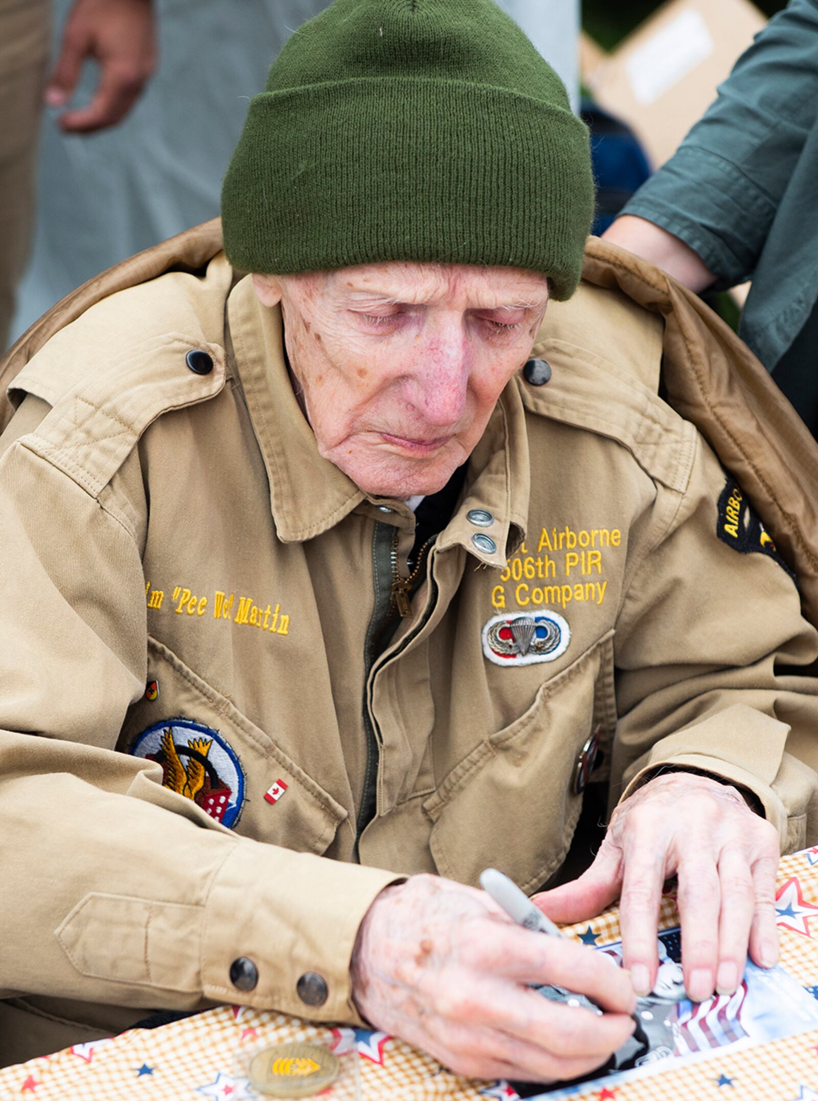 World War II veteran Jim “Pee Wee” Martin signs autographs during a 100th birthday celebration held in his honor April 23 in Xenia, Ohio. U.S. AIR FORCE PHOTO/WESLEY FARNSWORTH